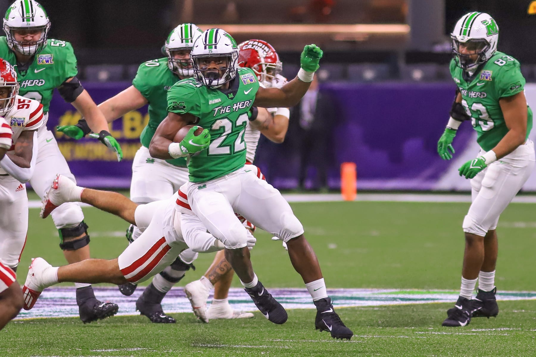 NEW ORLEANS, LA - DECEMBER 18: Marshall Thundering Herd running back Rasheen Ali (22) breaks a tackle during the R+L Carriers New Orleans Bowl between the Louisiana-Lafayette Ragin Cajuns and the Marshall Thundering Herd on December 18, 2021, the Caesars Superdome in New Orleans, LA. (Photo by Chris McDill/Icon Sportswire via Getty Images)
