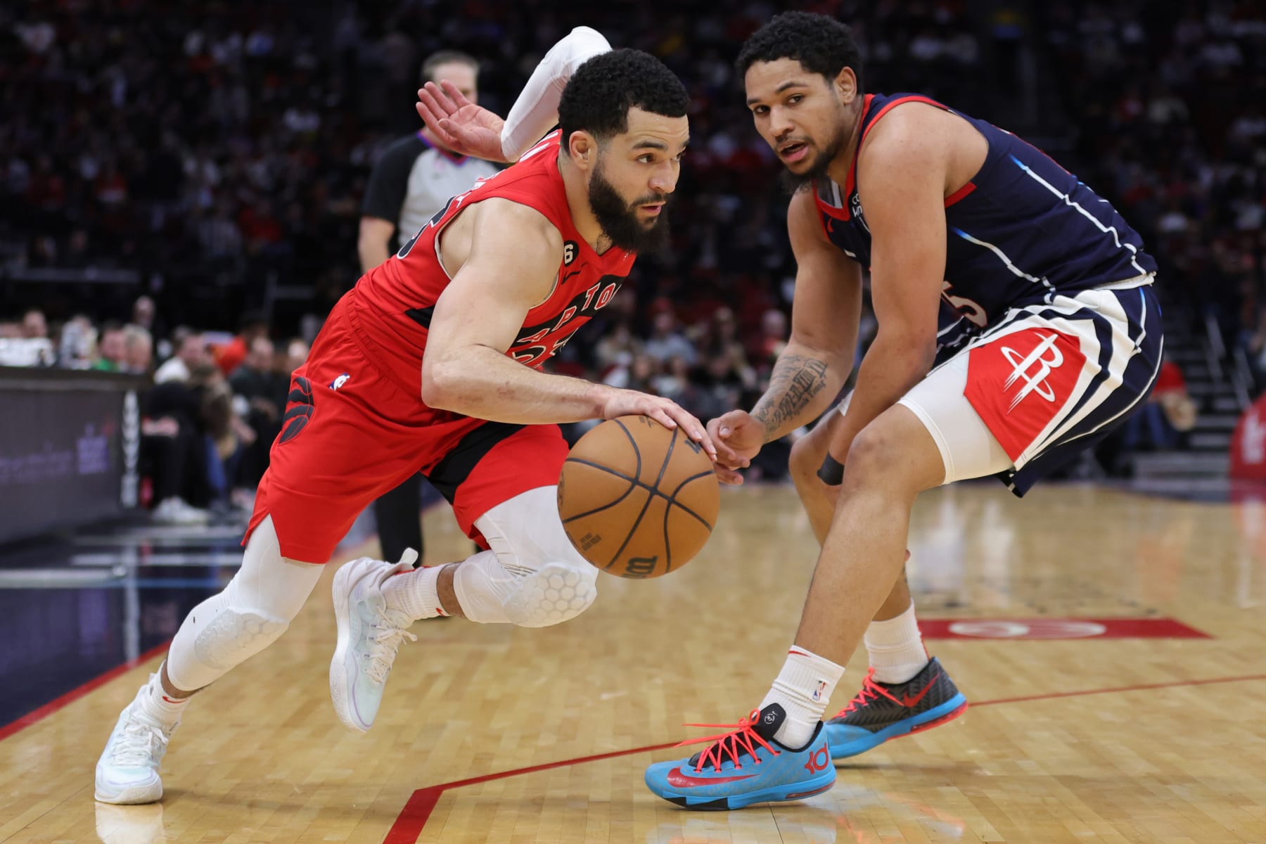 HOUSTON, TEXAS - FEBRUARY 03: Fred VanVleet #23 of the Toronto Raptors drives past Daishen Nix #15 of the Houston Rockets during the second half at Toyota Center on February 03, 2023 in Houston, Texas. NOTE TO USER: User expressly acknowledges and agrees that, by downloading and or using this photograph, User is consenting to the terms and conditions of the Getty Images License Agreement. (Photo by Carmen Mandato/Getty Images)