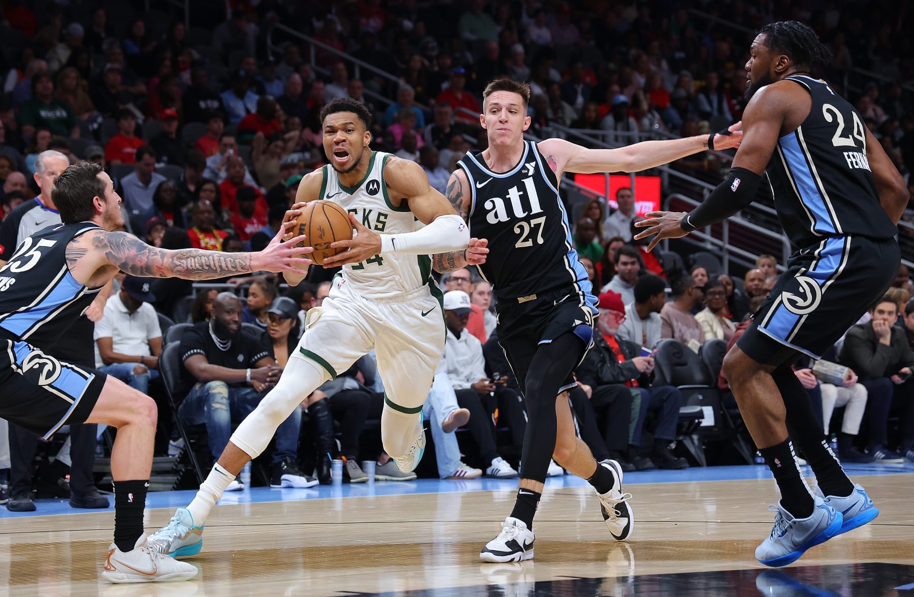 ATLANTA, GEORGIA - MARCH 30:  Giannis Antetokounmpo #34 of the Milwaukee Bucks drives against Garrison Mathews #25, Vit Krejci #27 and Bruno Fernando #24 of the Atlanta Hawks during the first quarter at State Farm Arena on March 30, 2024 in Atlanta, Georgia.  NOTE TO USER: User expressly acknowledges and agrees that, by downloading and/or using this photograph, user is consenting to the terms and conditions of the Getty Images License Agreement.  (Photo by Kevin C. Cox/Getty Images)