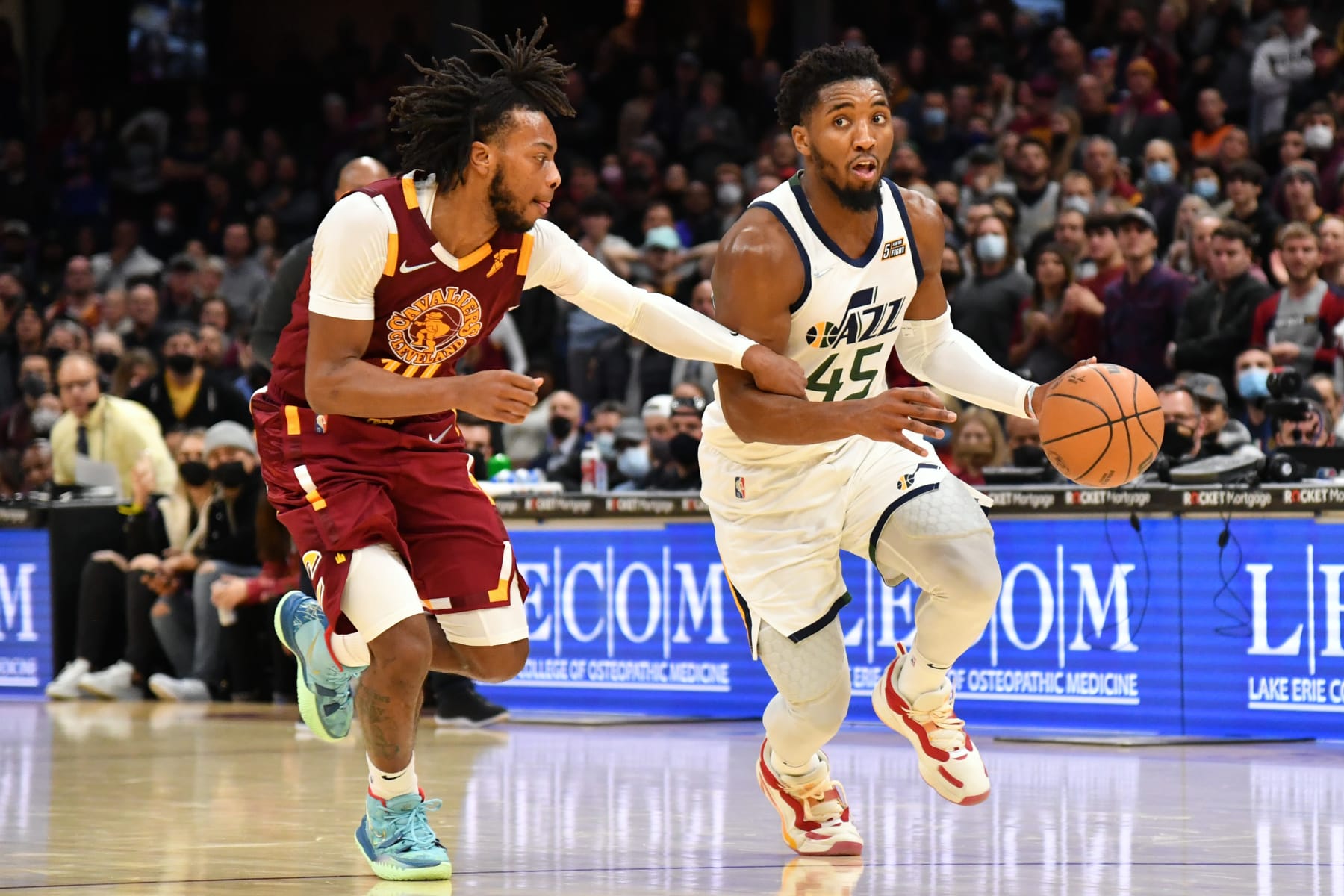 CLEVELAND, OHIO - DECEMBER 05: Donovan Mitchell #45 of the Utah Jazz drives to the basket around Darius Garland #10 of the Cleveland Cavaliers during the fourth quarter at Rocket Mortgage Fieldhouse on December 05, 2021 in Cleveland, Ohio. The Jazz defeated the Cavaliers 109-108. NOTE TO USER: User expressly acknowledges and agrees that, by downloading and/or using this photograph, user is consenting to the terms and conditions of the Getty Images License Agreement. (Photo by Jason Miller/Getty Images)