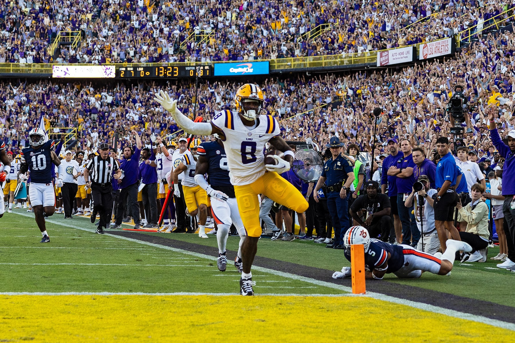 BATON ROUGE, LA - OCTOBER 14: LSU Tigers wide receiver Malik Nabers (8) scores a touchdown during a game between the LSU Tigers and the Auburn Tigers on October 14, 2023, at Tiger Stadium in Baton Rouge, Louisiana. (Photo by John Korduner/Icon Sportswire via Getty Images)