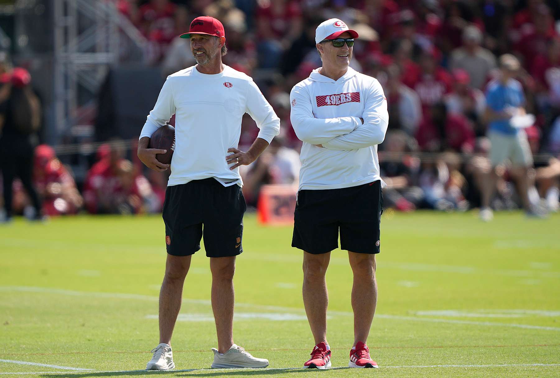 SANTA CLARA, CALIFORNIA - JULY 29: Head coach Kyle Shanahan (L) and General manager John Lynch (R) of the San Francisco 49ers looks on during training camp at SAP Performance Facility on July 29, 2024 in Santa Clara, California. (Photo by Thearon W. Henderson/Getty Images)