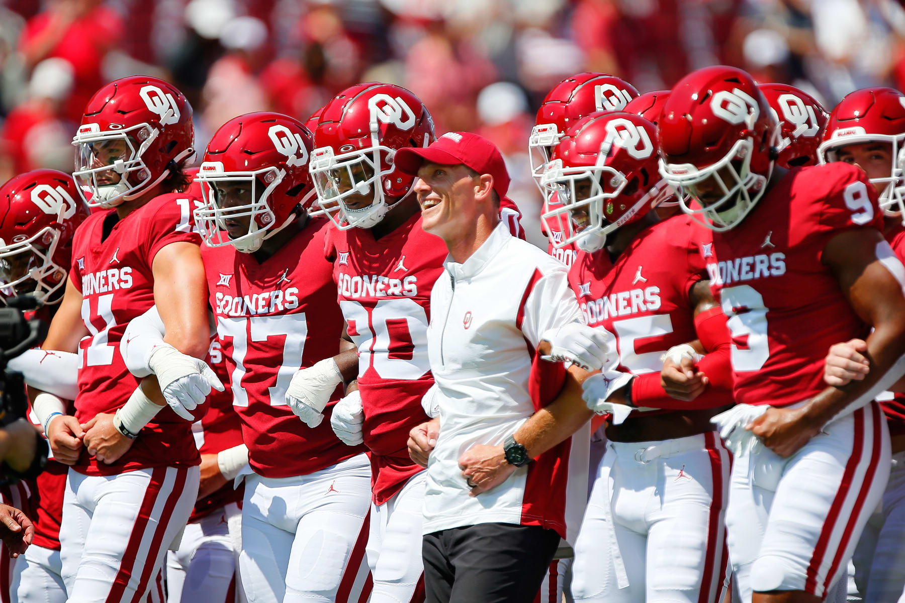 NORMAN, OK - SEPTEMBER 3:  Head coach Brent Venables of the Oklahoma Sooners walks arm in arm with his team before a game against the UTEP Miners at Gaylord Family Oklahoma Memorial Stadium on September 3, 2022 in Norman, Oklahoma.   (Photo by Brian Bahr/Getty Images)