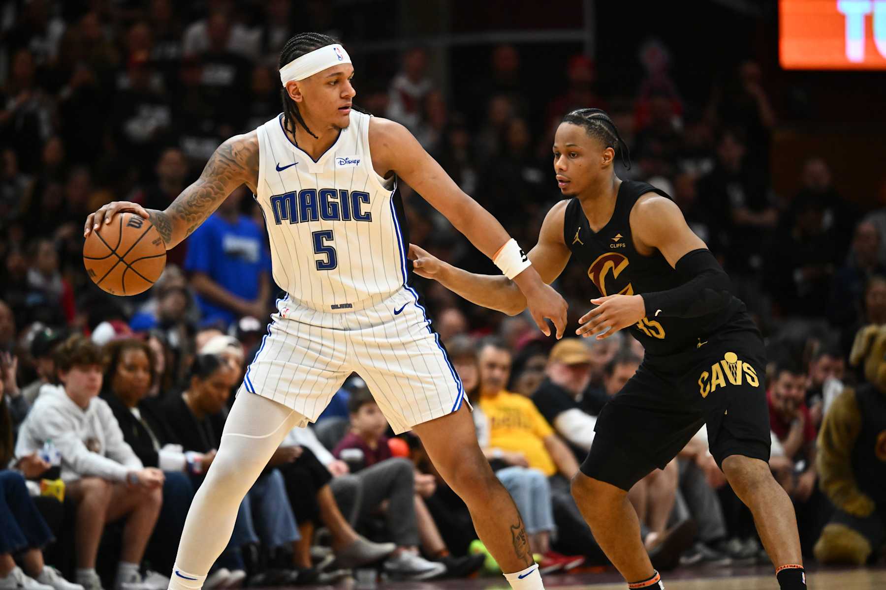CLEVELAND, OHIO - MAY 05: Paolo Banchero #5 of the Orlando Magic posts up against Isaac Okoro #35 of the Cleveland Cavaliers during the fourth quarter of Game Seven of the Eastern Conference First Round Playoffs at Rocket Mortgage Fieldhouse on May 05, 2024 in Cleveland, Ohio. The Cavaliers defeated the Magic 106-94. NOTE TO USER: User expressly acknowledges and agrees that, by downloading and/or using this Photograph, user is consenting to the terms and conditions of the Getty Images License Agreement. (Photo by Jason Miller/Getty Images)