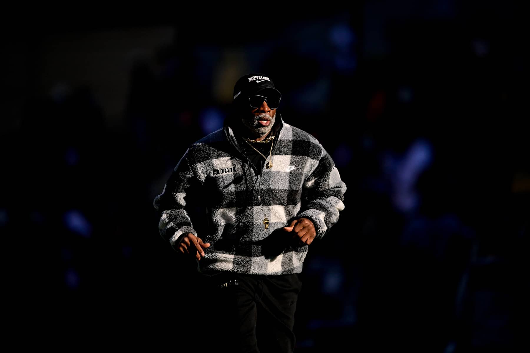 BOULDER, CO - NOVEMBER 16:  Head coach Deion Sanders of the Colorado Buffaloes runs on the field before a game between the Colorado Buffaloes and the Utah Utes at Folsom Field on November 16, 2024 in Boulder, Colorado. (Photo by Dustin Bradford/Getty Images)