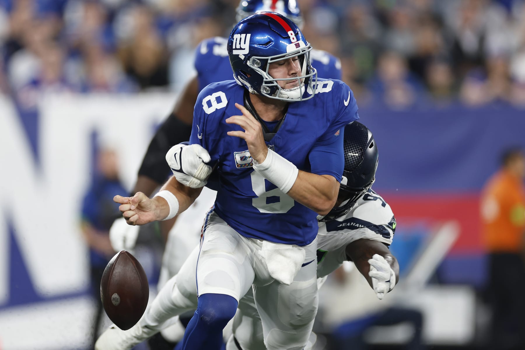 EAST RUTHERFORD, NEW JERSEY - OCTOBER 02: Daniel Jones #8 of the New York Giants has the ball stripped by Mario Edwards Jr. #97 of the Seattle Seahawks during the first quarter at MetLife Stadium on October 02, 2023 in East Rutherford, New Jersey. (Photo by Sarah Stier/Getty Images)