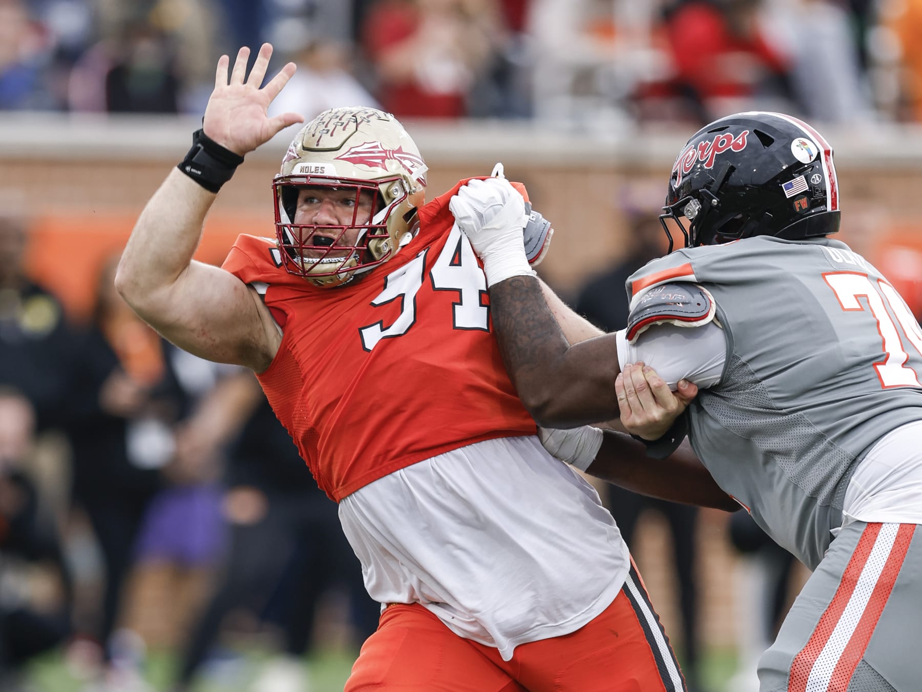 MOBILE, AL - FEBRUARY 03: Defensive Lineman Braden Fiske #94 of Florida State from the National Team is being blocked by Offensive Lineman Delmar Glaze #74 of Maryland from the American Team during the 2024 Reese's Senior Bowl at Hancock Whitney Stadium on the campus of the University of South Alabama on February 3, 2024 in Mobile, Alabama. he National Team defeated the American Team 16 to 7. (Photo by Don Juan Moore/Getty Images)