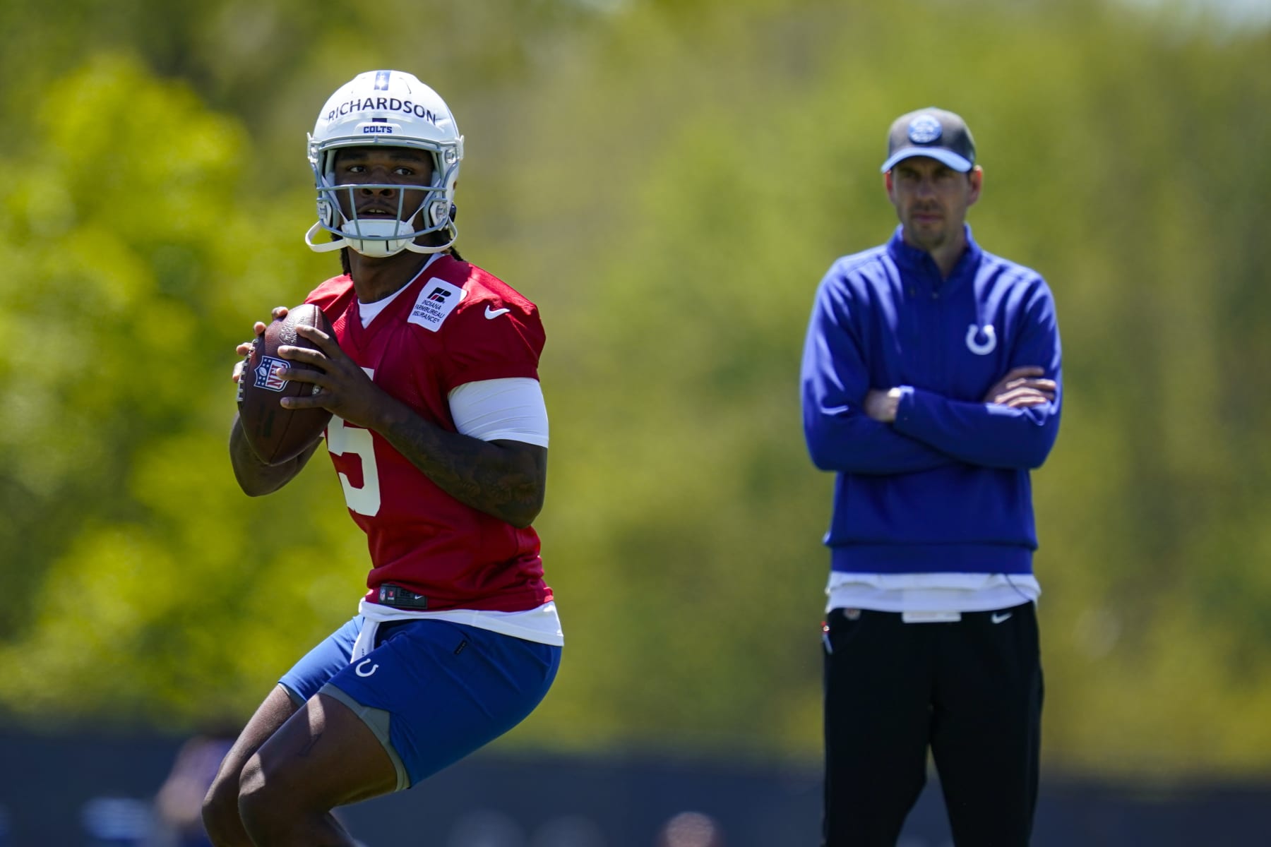 Indianapolis Colts quarterback Anthony Richardson throws in front of head coach Shane Steichen during a rookie camp at the NFL football team's practice facility in Indianapolis, Friday, May 5, 2023. (AP Photo/Michael Conroy)