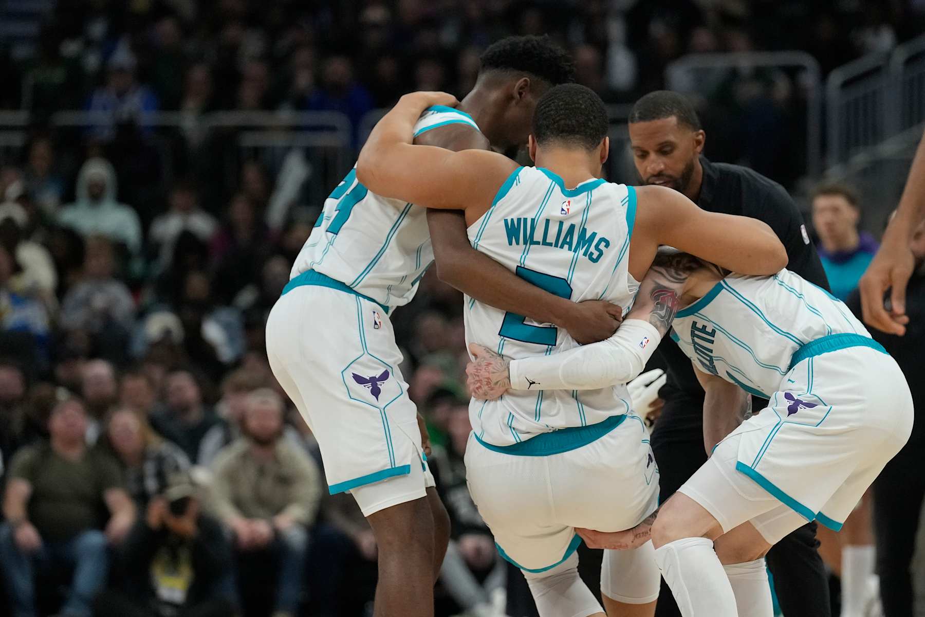 MILWAUKEE, WISCONSIN - NOVEMBER 23: Grant Williams #2 of the Charlotte Hornets helped by his teammates after being injured during the fourth quarter of a game against the Milwaukee Bucks at Fiserv Forum on November 23, 2024 in Milwaukee, Wisconsin. NOTE TO USER: User expressly acknowledges and agrees that, by downloading and or using this photograph, User is consenting to the terms and conditions of the Getty Images License Agreement. (Photo by Patrick McDermott/Getty Images)