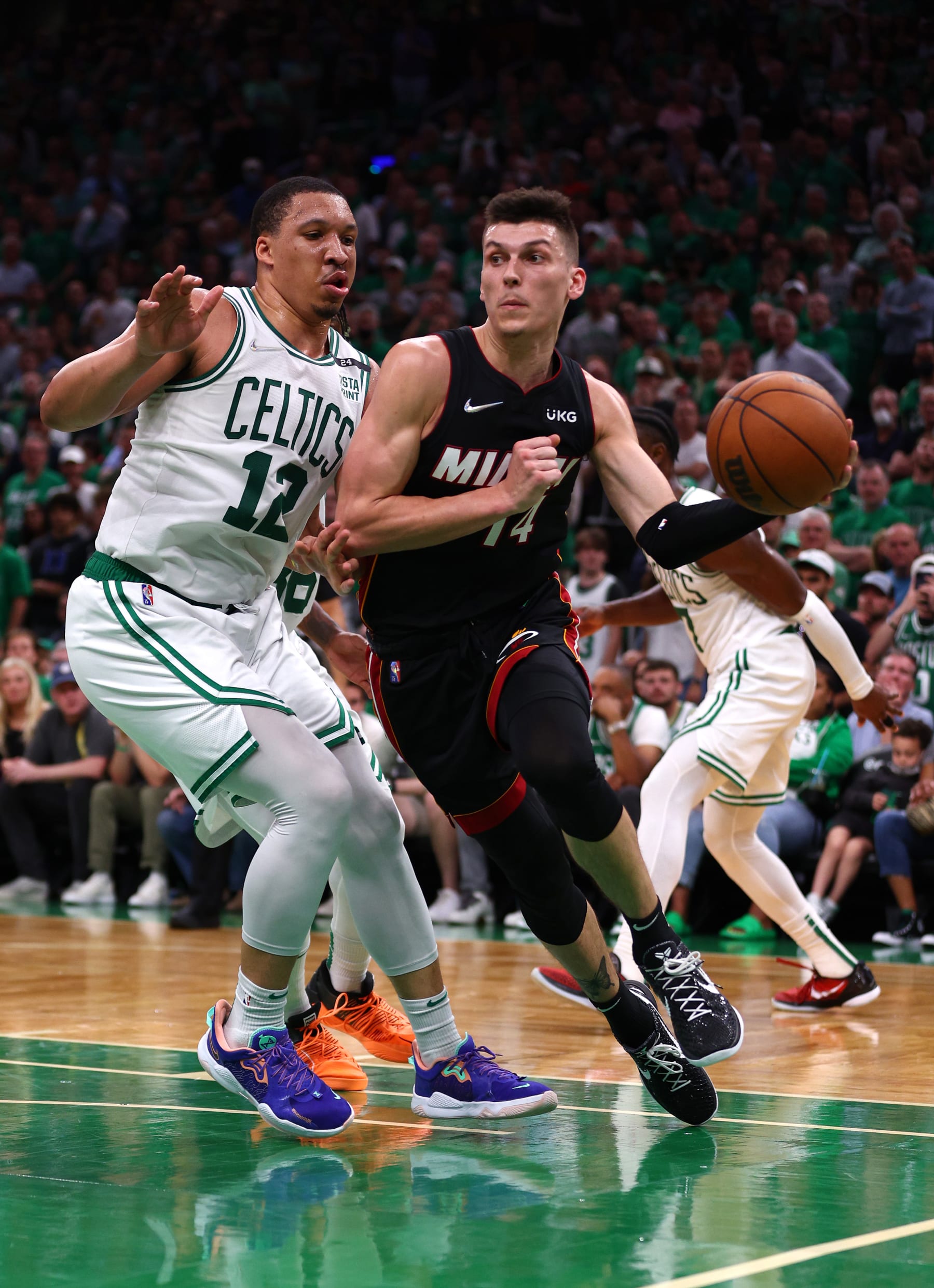BOSTON, MASSACHUSETTS - MAY 21: Tyler Herro #14 of the Miami Heat handles the ball against Grant Williams #12 of the Boston Celtics in the third uqarter in Game Three of the 2022 NBA Playoffs Eastern Conference Finals at TD Garden on May 21, 2022 in Boston, Massachusetts. NOTE TO USER: User expressly acknowledges and agrees that, by downloading and/or using this photograph, User is consenting to the terms and conditions of the Getty Images License Agreement.  (Photo by Elsa/Getty Images)