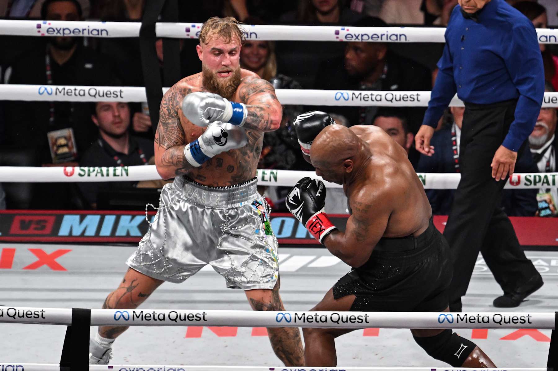 ARLINGTON, TEXAS - NOVEMBER 15: Mike Tyson (in black short) and Jake Paul (in silver short) exchange punches during their heavyweight world titles of the Premiere Boxing Championship on Friday night at AT&T Stadium in Arlington, Texas, United States on November 15, 2024. (Photo by Tayfun Coskun/Anadolu via Getty Images)