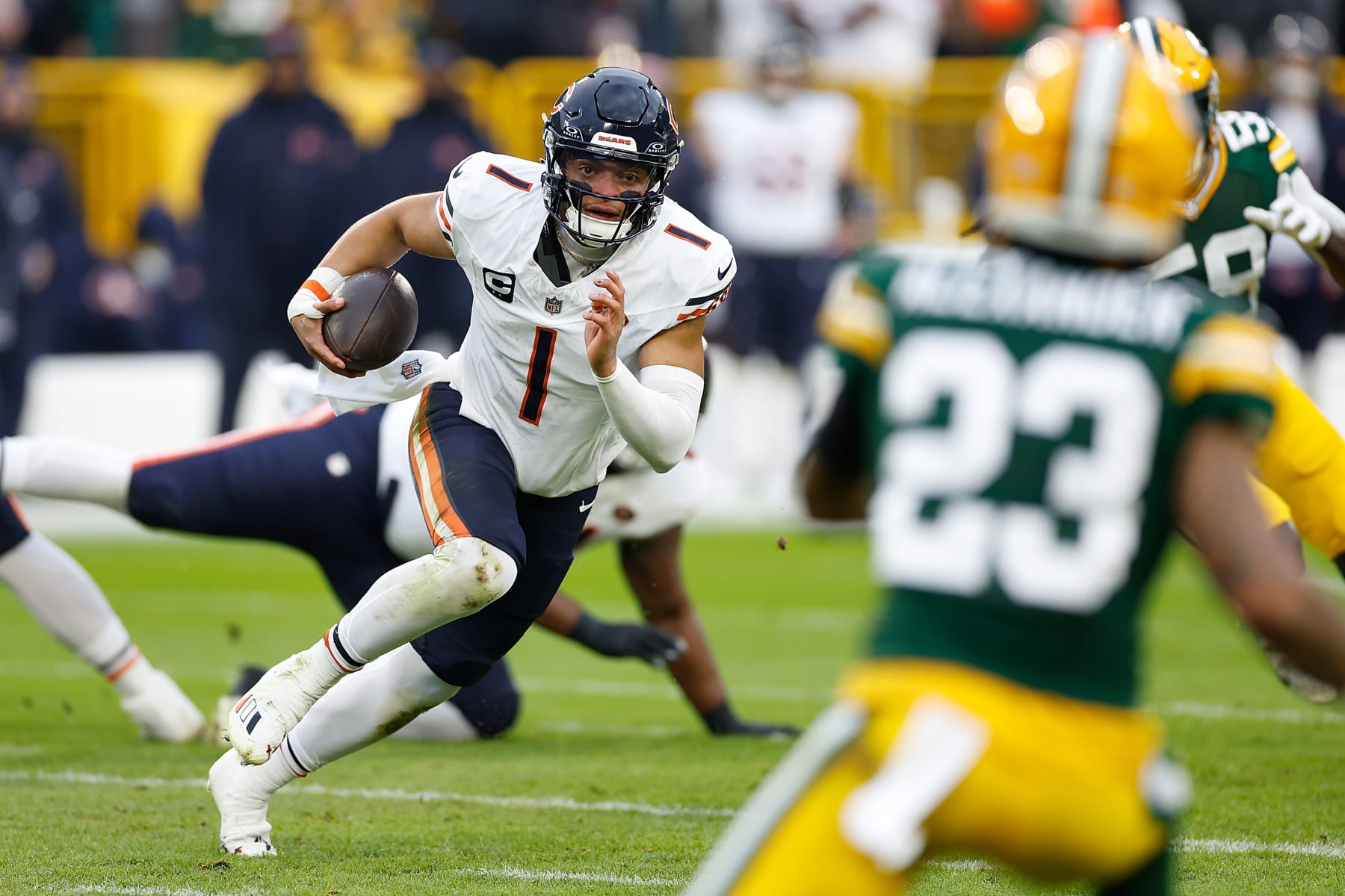 GREEN BAY, WISCONSIN - JANUARY 07: Justin Fields #1 of the Chicago Bears takes off running during the first half against the Green Bay Packers at Lambeau Field on January 07, 2024 in Green Bay, Wisconsin. (Photo by John Fisher/Getty Images)