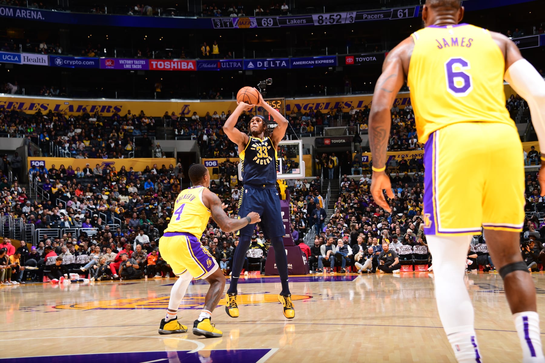 LOS ANGELES, CA - NOVEMBER 28: Myles Turner #33 of the Indiana Pacers shoots a three point basket over defender Lonnie Walker IV #4 of the Los Angeles Lakers during the game on November 28, 2022 at Crypto.Com Arena in Los Angeles, California. NOTE TO USER: User expressly acknowledges and agrees that, by downloading and/or using this Photograph, user is consenting to the terms and conditions of the Getty Images License Agreement. Mandatory Copyright Notice: Copyright 2022 NBAE (Photo by Adam Pantozzi/NBAE via Getty Images)