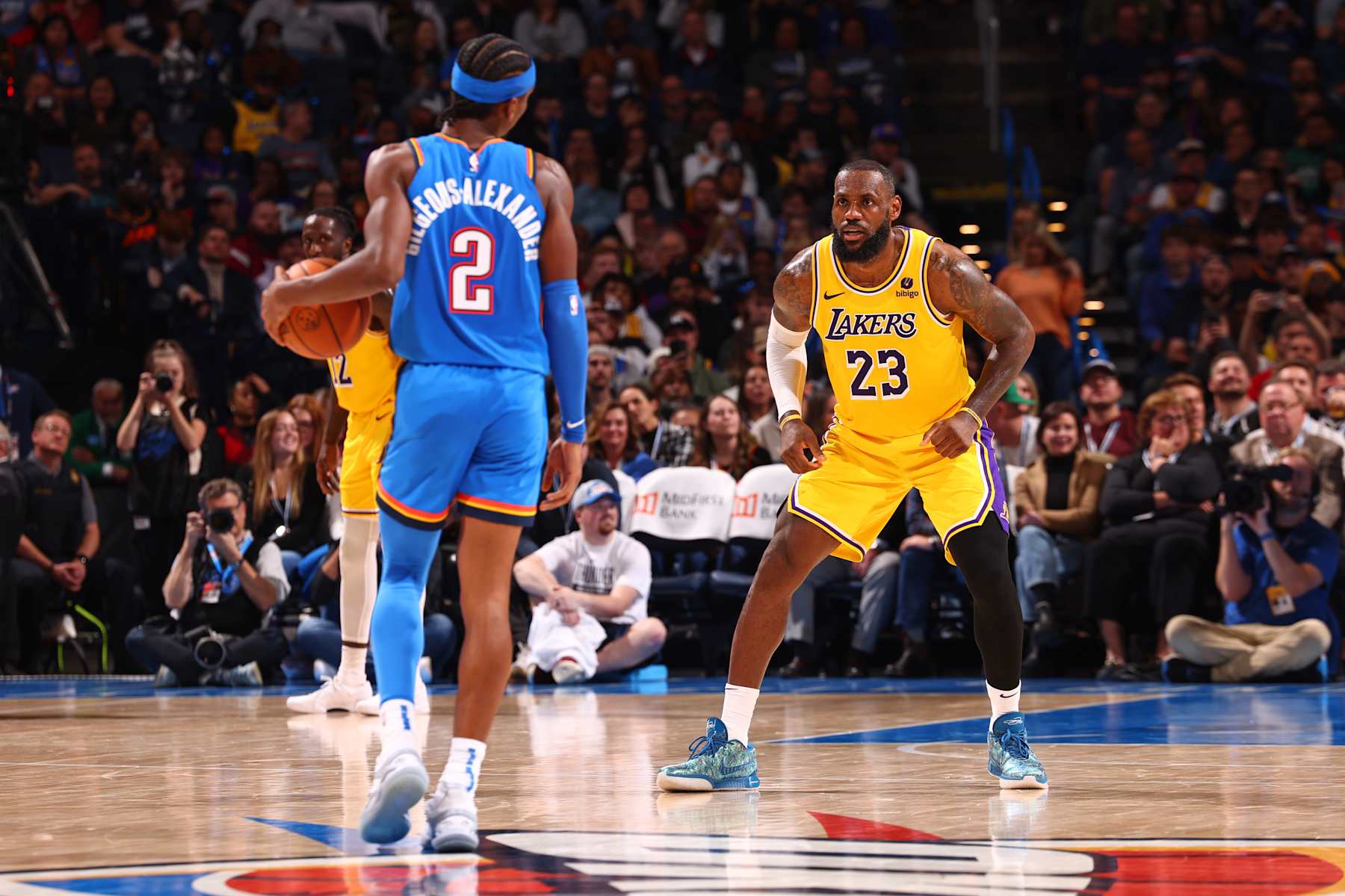 OKLAHOMA CITY, OK - NOVEMBER 30: LeBron James #23 of the Los Angeles Lakers defends Shai Gilgeous-Alexander #2 of the Oklahoma City Thunder during the game on November 30, 2023 at Paycom Arena in Oklahoma City, Oklahoma. NOTE TO USER: User expressly acknowledges and agrees that, by downloading and or using this photograph, User is consenting to the terms and conditions of the Getty Images License Agreement. Mandatory Copyright Notice: Copyright 2023 NBAE (Photo by Zach Beeker/NBAE via Getty Images)