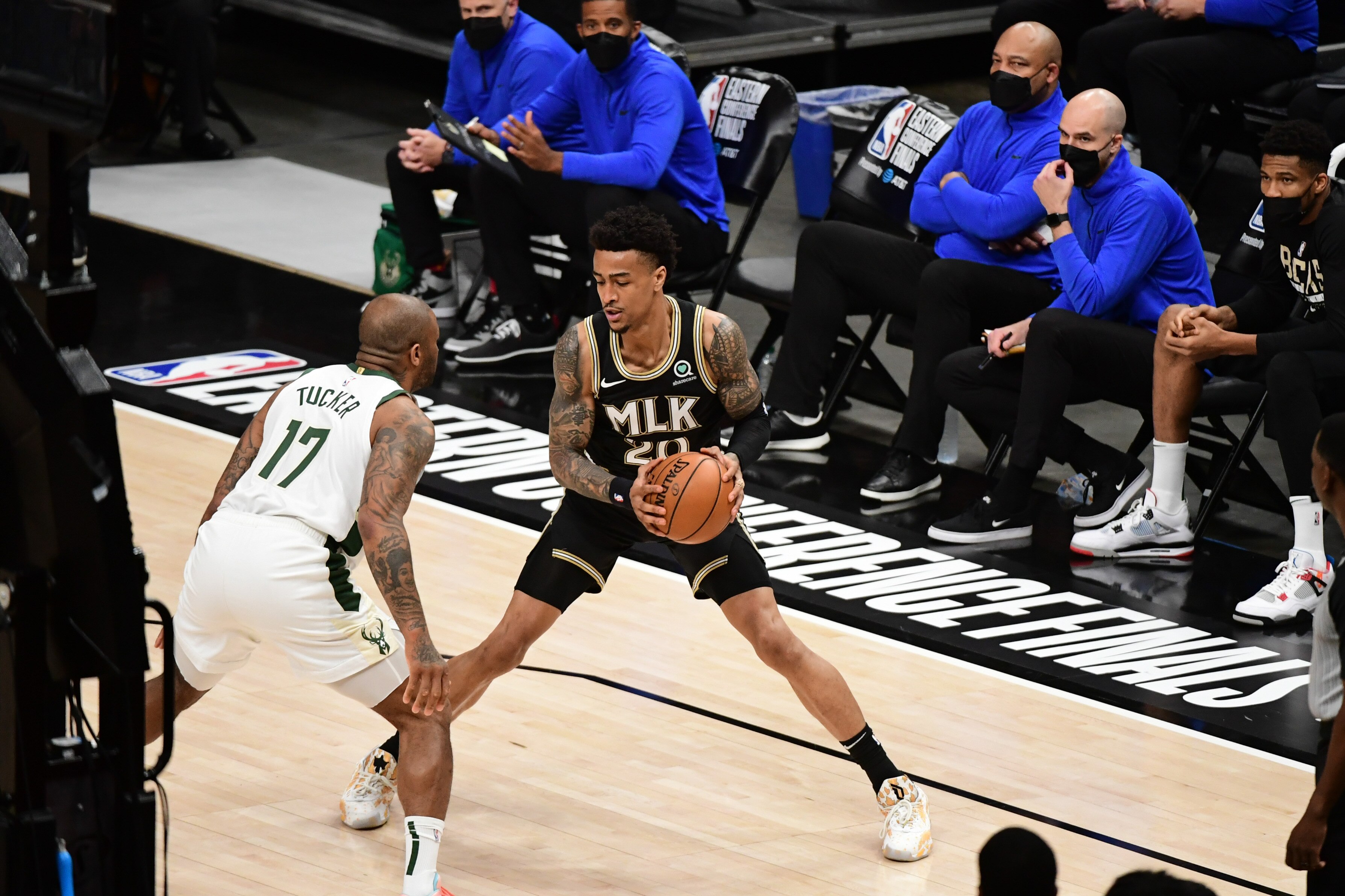 ATLANTA, GA - JULY 3: John Collins #20 of the Atlanta Hawks handles the ball as P.J. Tucker #17 of the Milwaukee Bucks plays defense during the game during Game 6 of the Eastern Conference Finals of the 2021 NBA Playoffs on July 3, 2021 at State Farm Arena in Atlanta, Georgia.  NOTE TO USER: User expressly acknowledges and agrees that, by downloading and/or using this Photograph, user is consenting to the terms and conditions of the Getty Images License Agreement. Mandatory Copyright Notice: Copyright 2021 NBAE (Photo by Adam Hagy/NBAE via Getty Images)
