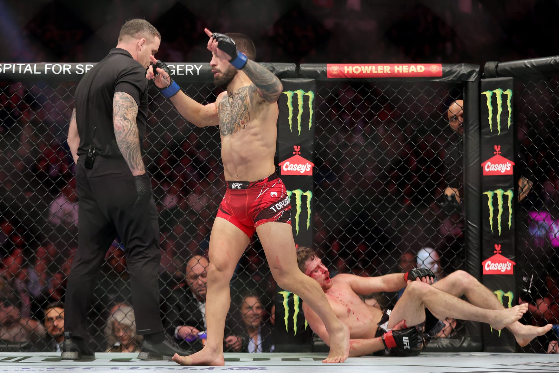 LAS VEGAS, NEVADA - DECEMBER 10: (L-R) Ilia Topuria reacts after defeating Bryce Mitchell by submission during the UFC 282 event at T-Mobile Arena on December 10, 2022 in Las Vegas, Nevada. (Photo by Carmen Mandato/Zuffa LLC)
