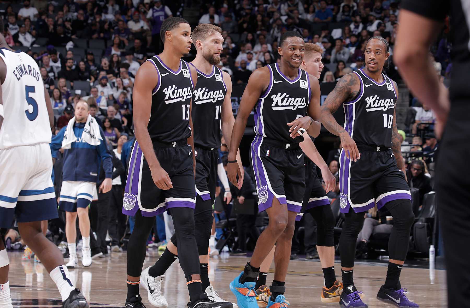 SACRAMENTO, CA - OCTOBER 24: Keegan Murray #13, Domantas Sabonis #11, De'Aaron Fox #5, Kevin Huerter #9, and DeMar DeRozan #10 of the Sacramento Kings walk to the bench during a timeout during the game against the Minnesota Timberwolves on October 24, 2024 at Golden 1 Center in Sacramento, California. NOTE TO USER: User expressly acknowledges and agrees that, by downloading and or using this photograph, User is consenting to the terms and conditions of the Getty Images Agreement. Mandatory Copyright Notice: Copyright 2024 NBAE (Photo by Rocky Widner/NBAE via Getty Images)