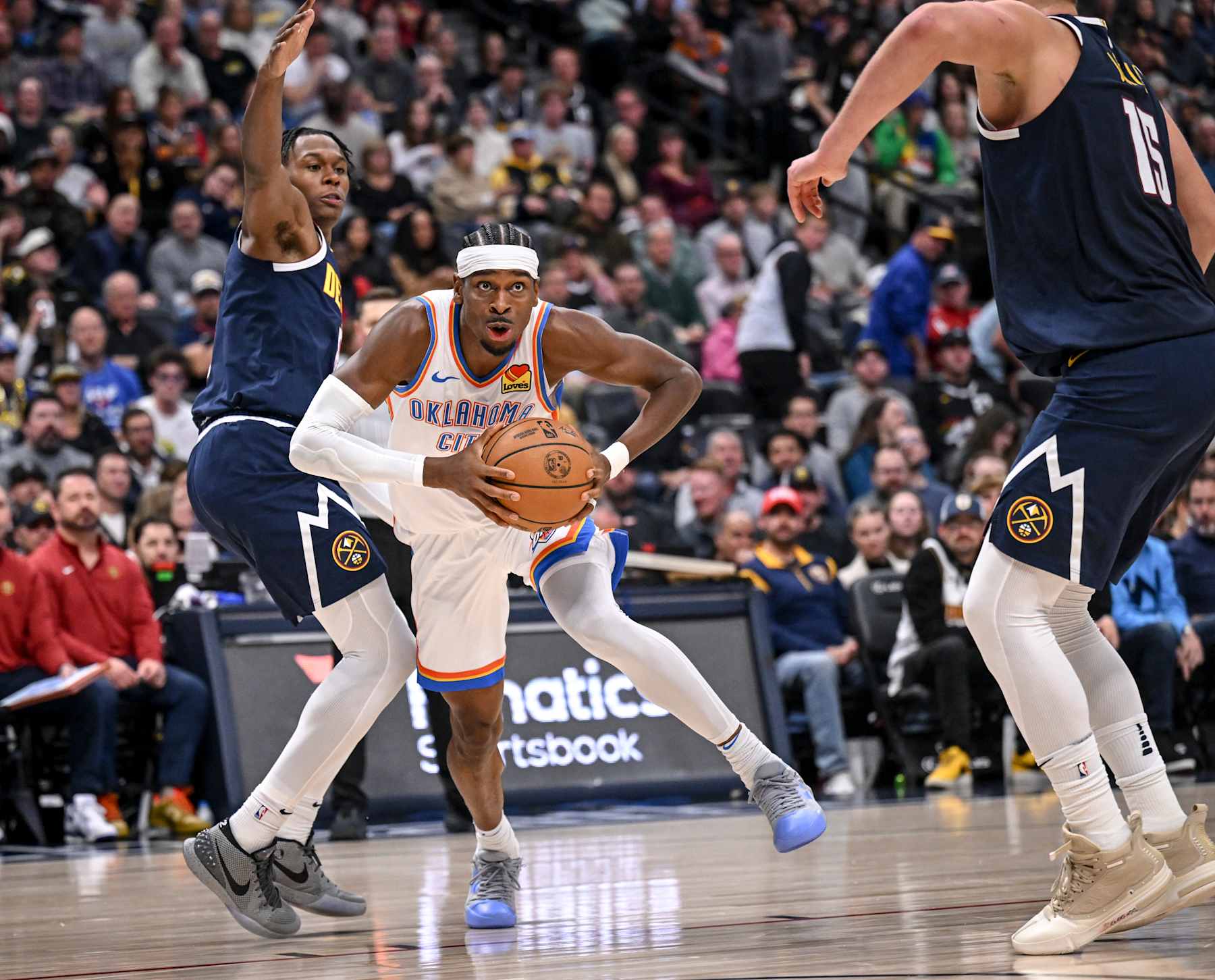 DENVER, CO - NOVEMBER 6: Shai Gilgeous-Alexander (2) of the Oklahoma City Thunder drives past Peyton Watson (8) of the Denver Nuggets during the second quarter at Ball Arena in Denver, Colorado on Wednesday, November 6, 2024. (Photo by AAron Ontiveroz/The Denver Post)