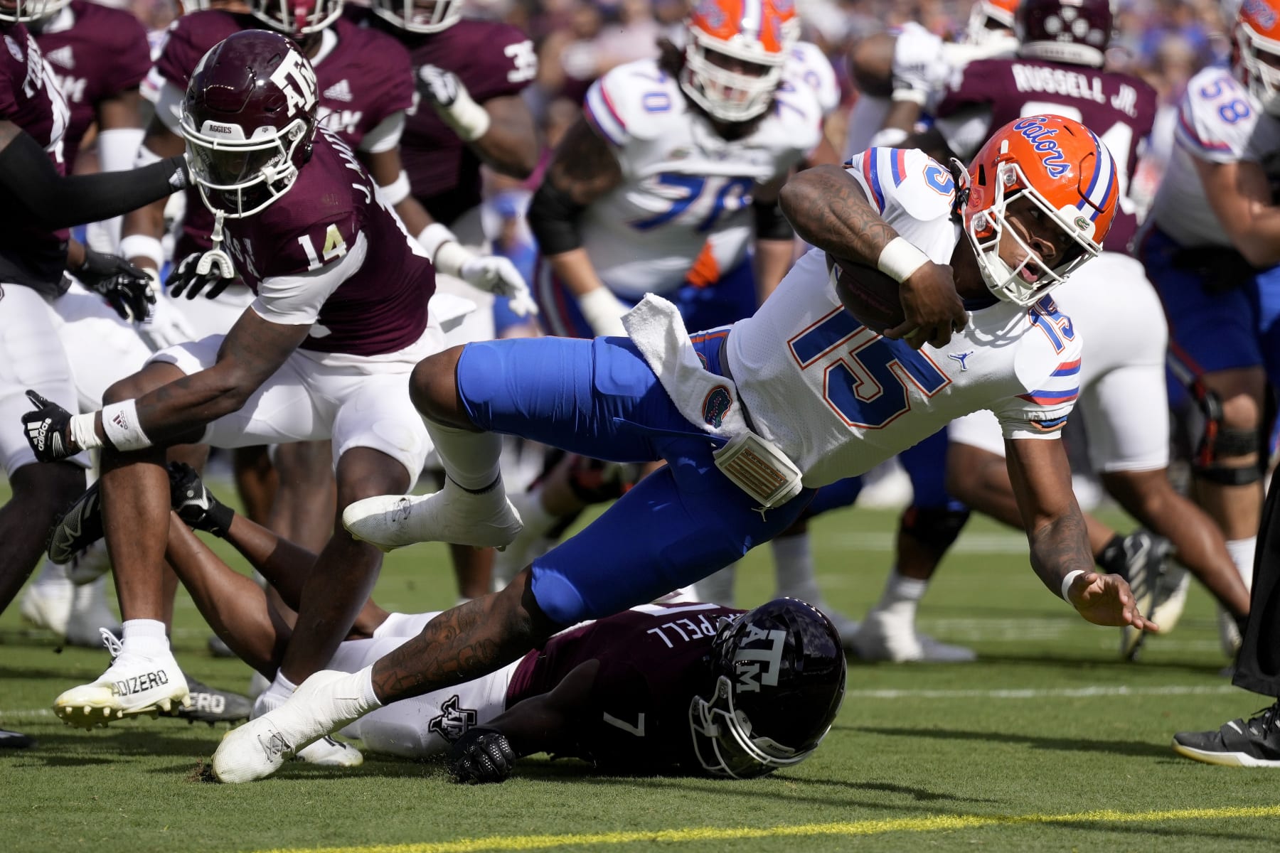 Florida quarterback Anthony Richardson (15) dives past Texas A&M defensive back Jacoby Mathews (14) for a touchdown during the first quarter of an NCAA college football game Saturday, Nov. 5, 2022, in College Station, Texas. (AP Photo/Sam Craft)