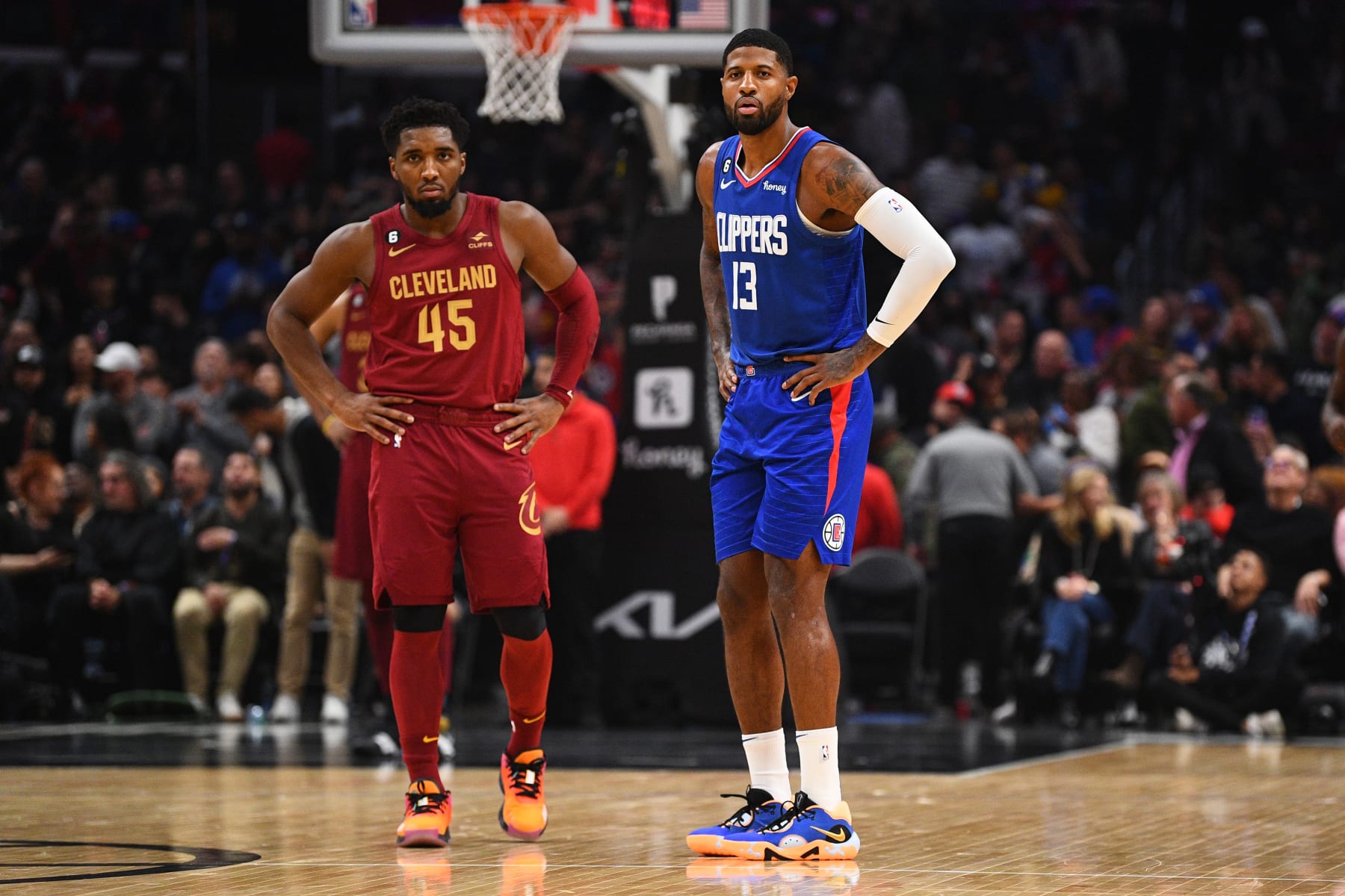 LOS ANGELES, CA - NOVEMBER 07:  Los Angeles Clippers Forward Paul George (13) looks on with Cleveland Cavaliers Guard Donovan Mitchell (45) during a NBA game between the Cleveland Cavaliers and the Los Angeles Clippers on November 7, 2022 at Crypto.com Arena in Los Angeles, CA. (Photo by Brian Rothmuller/Icon Sportswire via Getty Images)