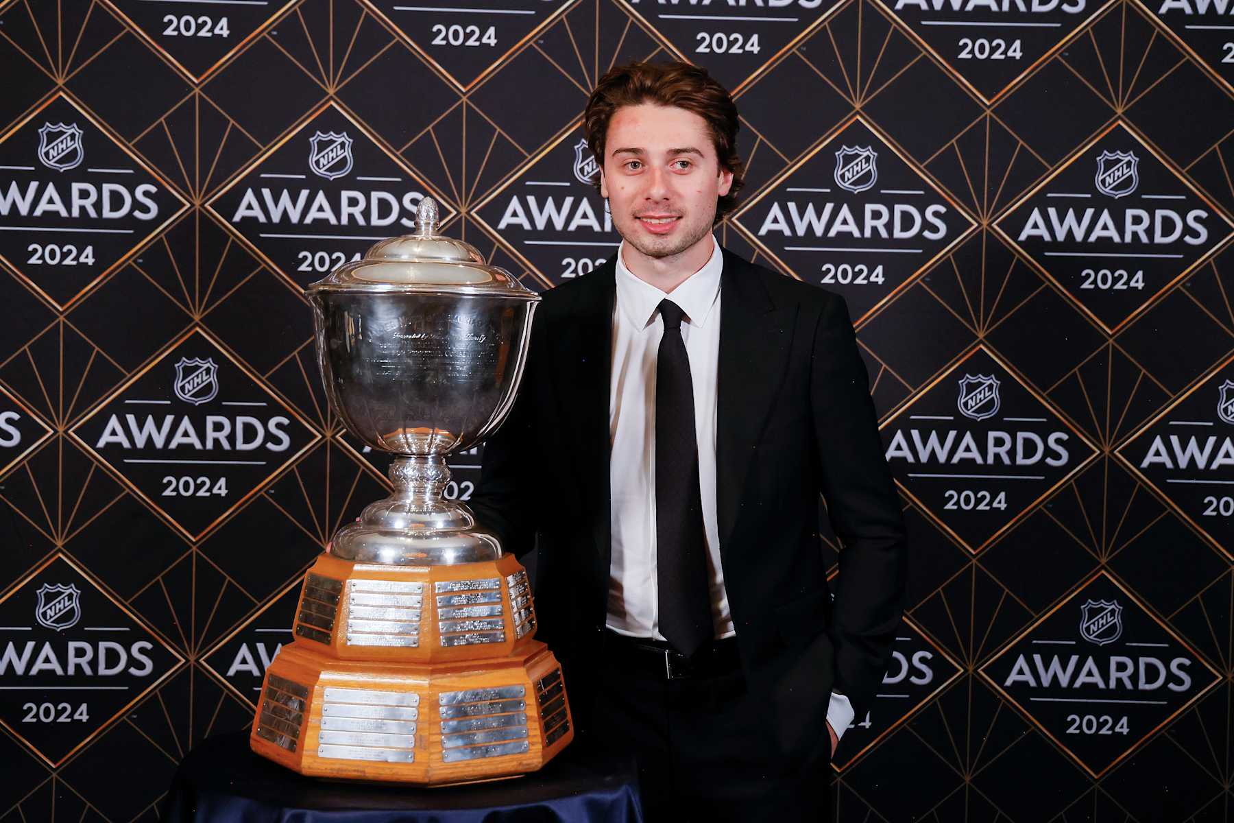 LAS VEGAS, NEVADA - JUNE 27:  Quinn Hughes of the Vancouver Canucks poses with the James Norris Memorial Trophy during the 2024 NHL Awards at BleauLive Theater at Fontainebleau Las Vegas on June 27, 2024 in Las Vegas, Nevada. (Photo by Bruce Bennett/Getty Images)