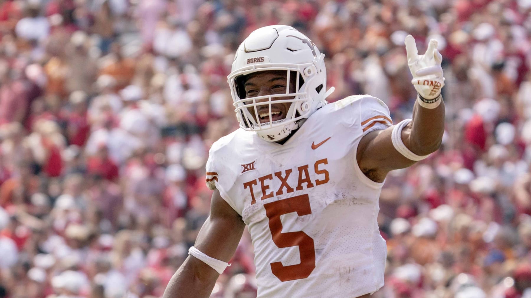 Texas running back Bijan Robinson (5) celebrates a touchdown during the second half of an NCAA college football game against Oklahoma at the Cotton Bowl, Saturday, Oct. 8, 2022, in Dallas. Texas won 49-0. (AP Photo/Jeffrey McWhorter)