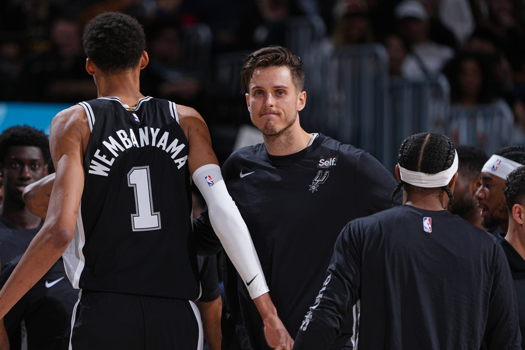 DENVER, CO - APRIL 2: Zach Collins #23 of the San Antonio Spurs high fives Victor Wembanyama #1 during the game against the Denver Nuggets on April 2, 2024 at the Ball Arena in Denver, Colorado. NOTE TO USER: User expressly acknowledges and agrees that, by downloading and/or using this Photograph, user is consenting to the terms and conditions of the Getty Images License Agreement. Mandatory Copyright Notice: Copyright 2024 NBAE (Photo by Garrett Ellwood/NBAE via Getty Images)