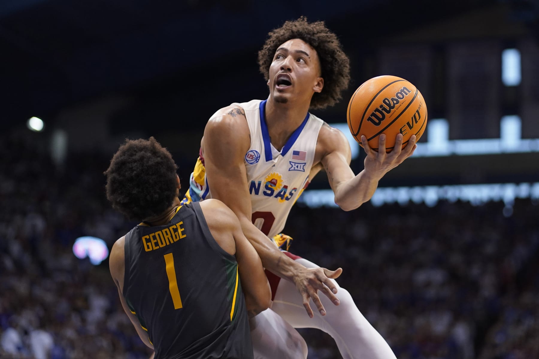 LAWRENCE, KANSAS - FEBRUARY 18: Jalen Wilson #10 of the Kansas Jayhawks lays the ball up over Keyonte George #1 of the Baylor Bears in the first half of the game at Allen Fieldhouse on February 18, 2023 in Lawrence, Kansas. (Photo by Ed Zurga/Getty Images)