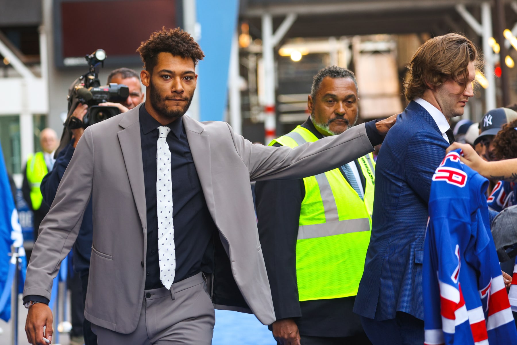 NEW YORK, NEW YORK - OCTOBER 11:  K'Andre Miller #79 and Jacob Trouba #8 of the New York Rangers walk the blue carpet prior to the home opener against the Tampa Bay Lightning at Madison Square Garden on October 11, 2022 in New York City. (Photo by Jared Silber/NHLI via Getty Images)