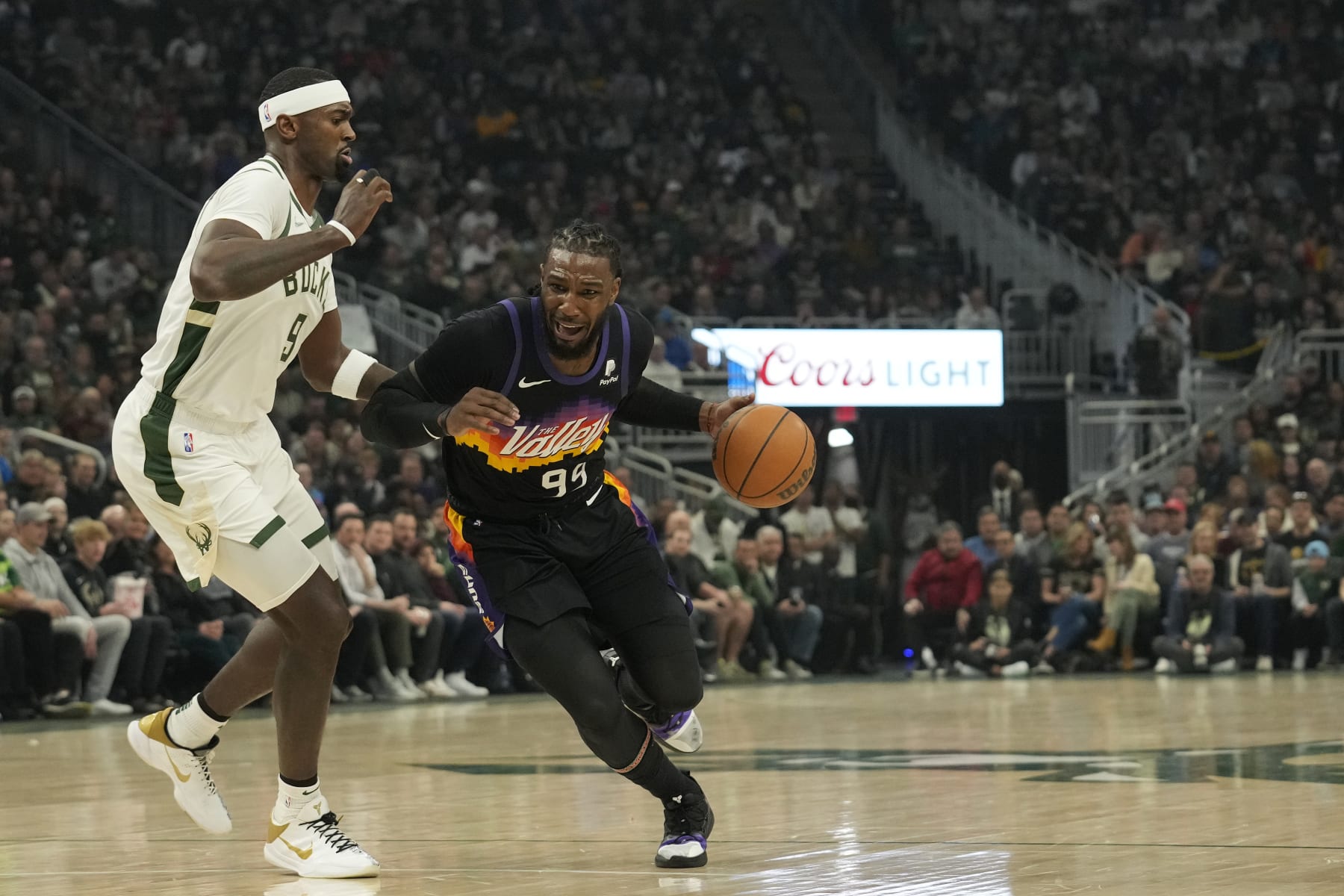 MILWAUKEE, WISCONSIN - MARCH 06: Jae Crowder #99 of the Phoenix Suns dribbles the ball against Bobby Portis #9 of the Milwaukee Bucks during the first half at Fiserv Forum on March 06, 2022 in Milwaukee, Wisconsin. NOTE TO USER: User expressly acknowledges and agrees that, by downloading and or using this photograph, User is consenting to the terms and conditions of the Getty Images License Agreement. (Photo by Patrick McDermott/Getty Images)