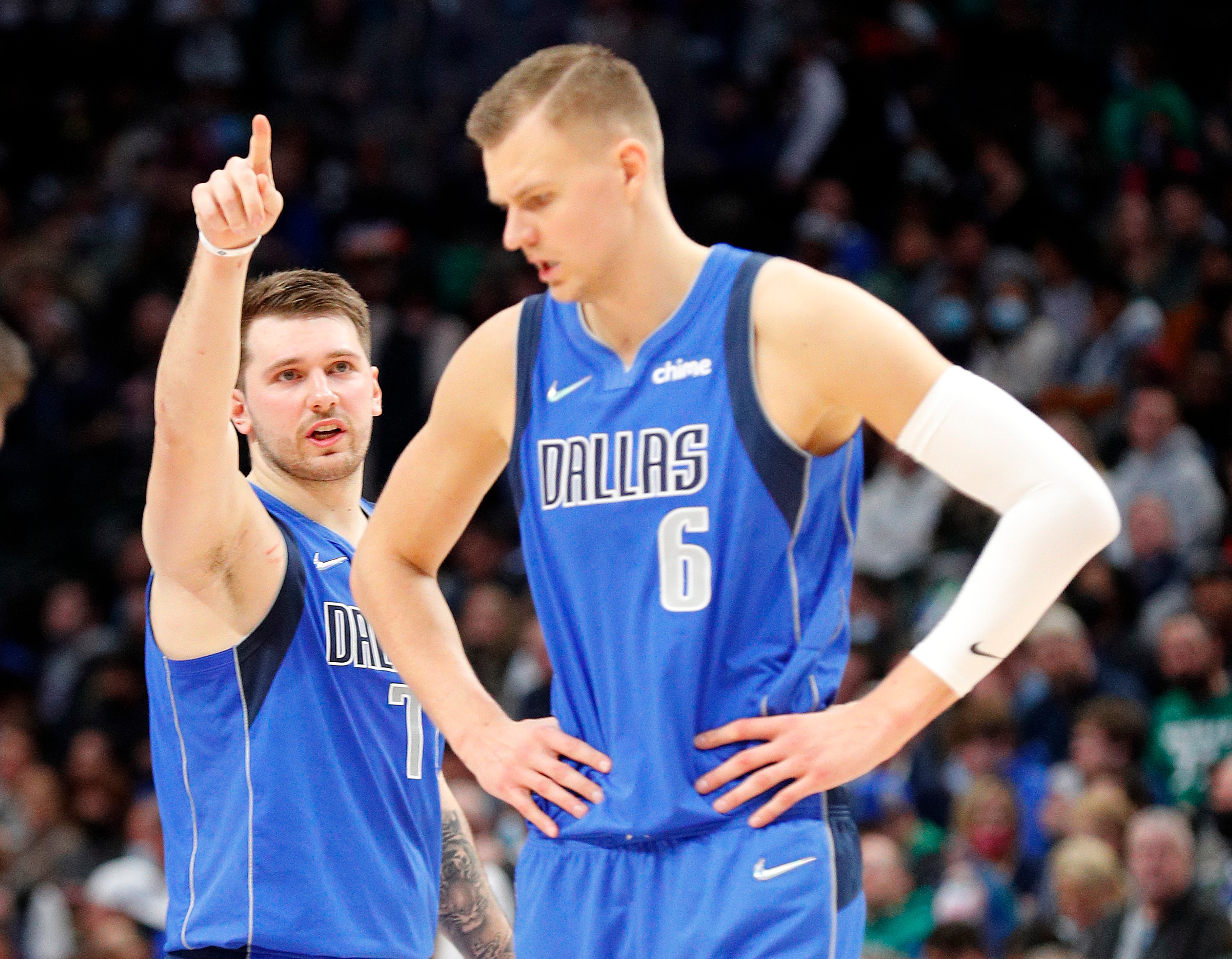 DALLAS, TEXAS - JANUARY 20: Luka Doncic #77 gestures as he talks to Kristaps Porzingis #6 of the Dallas Mavericks in the first half against the Phoenix Suns at American Airlines Center on January 20, 2022 in Dallas, Texas. NOTE TO USER: User expressly acknowledges and agrees that,  by downloading and or using this photograph,  User is consenting to the terms and conditions of the Getty Images License Agreement.  (Photo by Richard Rodriguez/Getty Images)