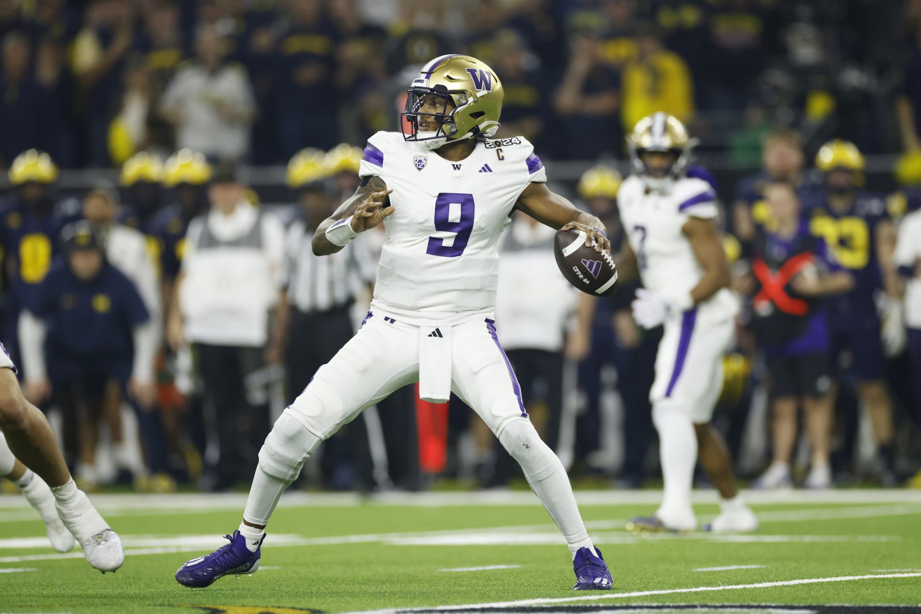 HOUSTON, TX - JANUARY 08: QB Michael Penix Jr. (9) of the Washington Huskies sets to pass during the Michigan Wolverines versus the Washington Huskies CFP National Championship game on January 8, 2024, at NRG Stadium in Houston, TX. (Photo by Joe Robbins/Icon Sportswire via Getty Images)