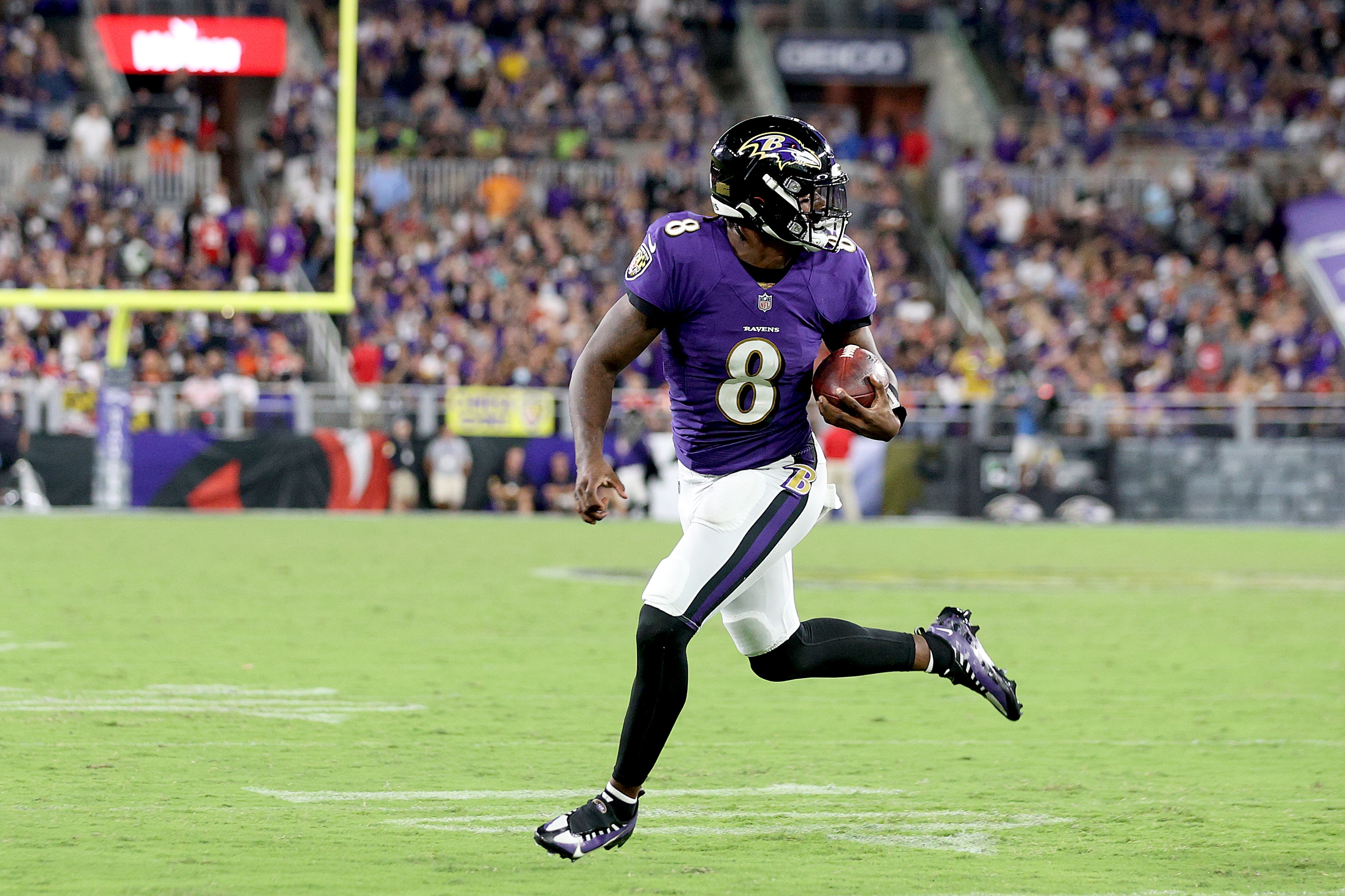 BALTIMORE, MARYLAND - SEPTEMBER 19: Lamar Jackson #8 of the Baltimore Ravens rushes for a touchdown against the Kansas City Chiefs during the fourth quarter at M&T Bank Stadium on September 19, 2021 in Baltimore, Maryland. (Photo by Rob Carr/Getty Images)