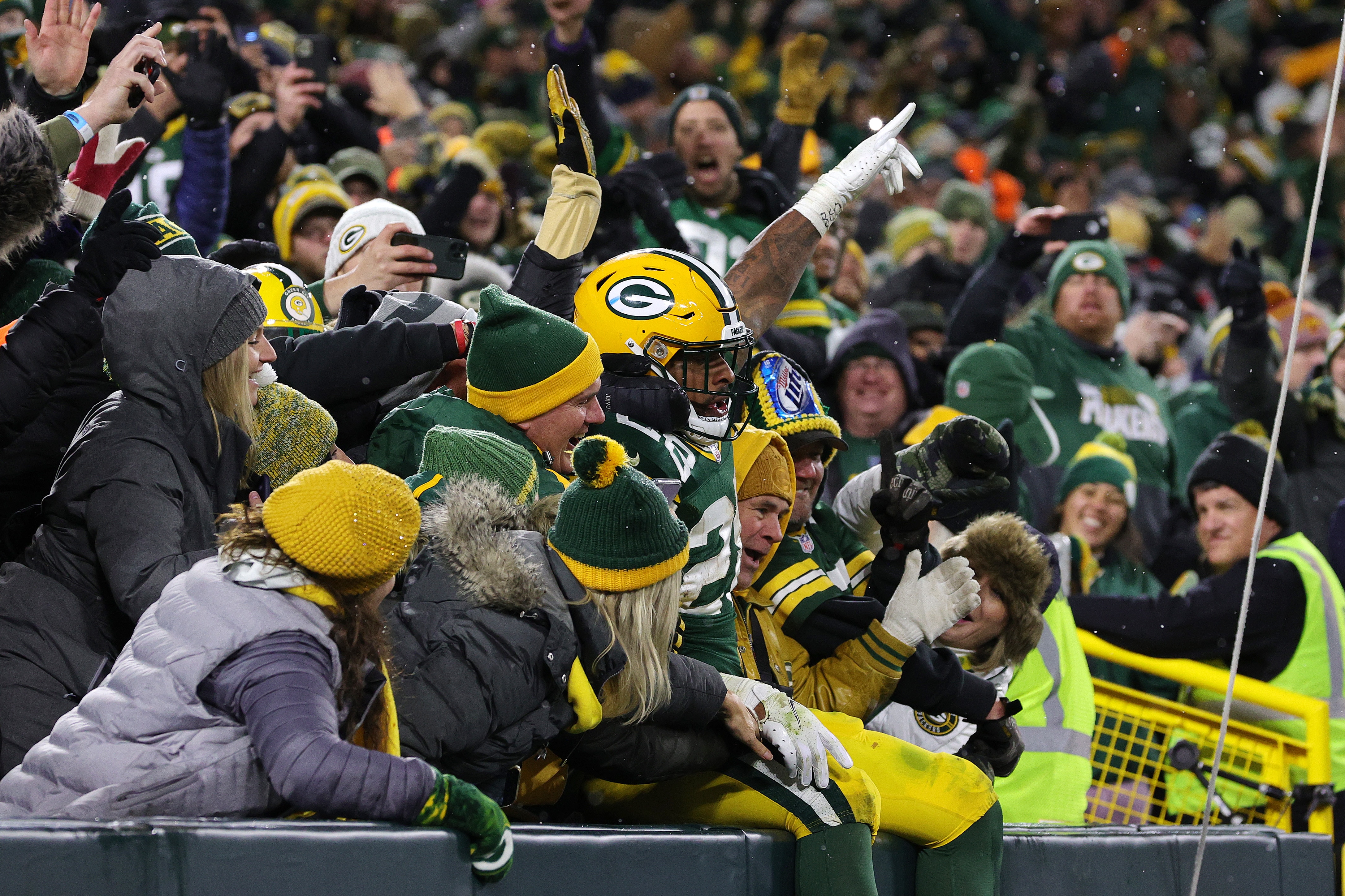 GREEN BAY, WISCONSIN - NOVEMBER 14: A.J. Dillon #28 of the Green Bay Packers celebates with fans after scoring a touchdown against the Seattle Seahawks during the fourth quarter at Lambeau Field on November 14, 2021 in Green Bay, Wisconsin. (Photo by Stacy Revere/Getty Images)