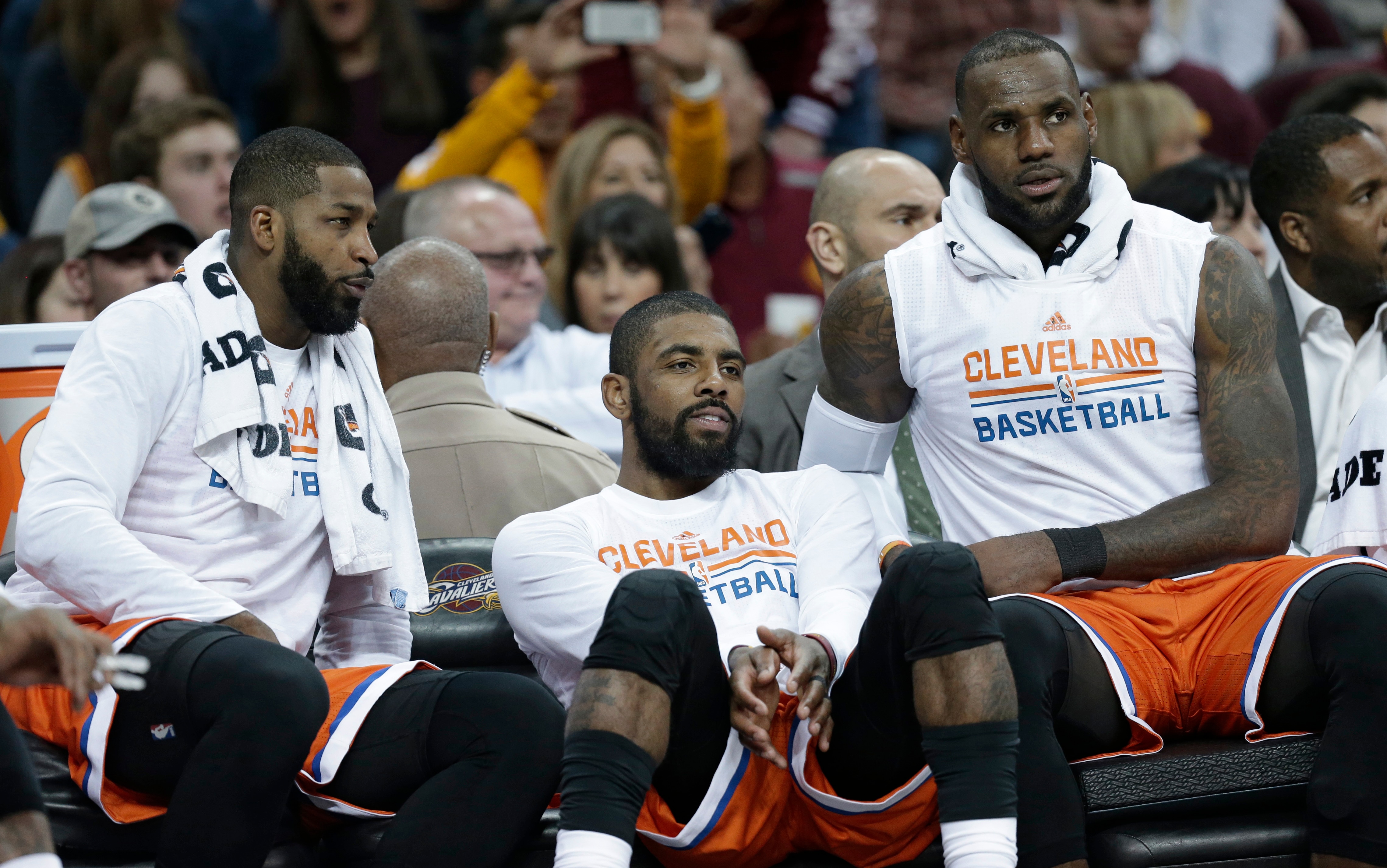 Cleveland Cavaliers' Tristan Thompson, left to right, Kyrie Irving and LeBron James watch from the bench in the second half of an NBA basketball game against the Philadelphia 76ers, Friday, March 31, 2017, in Cleveland. (AP Photo/Tony Dejak)