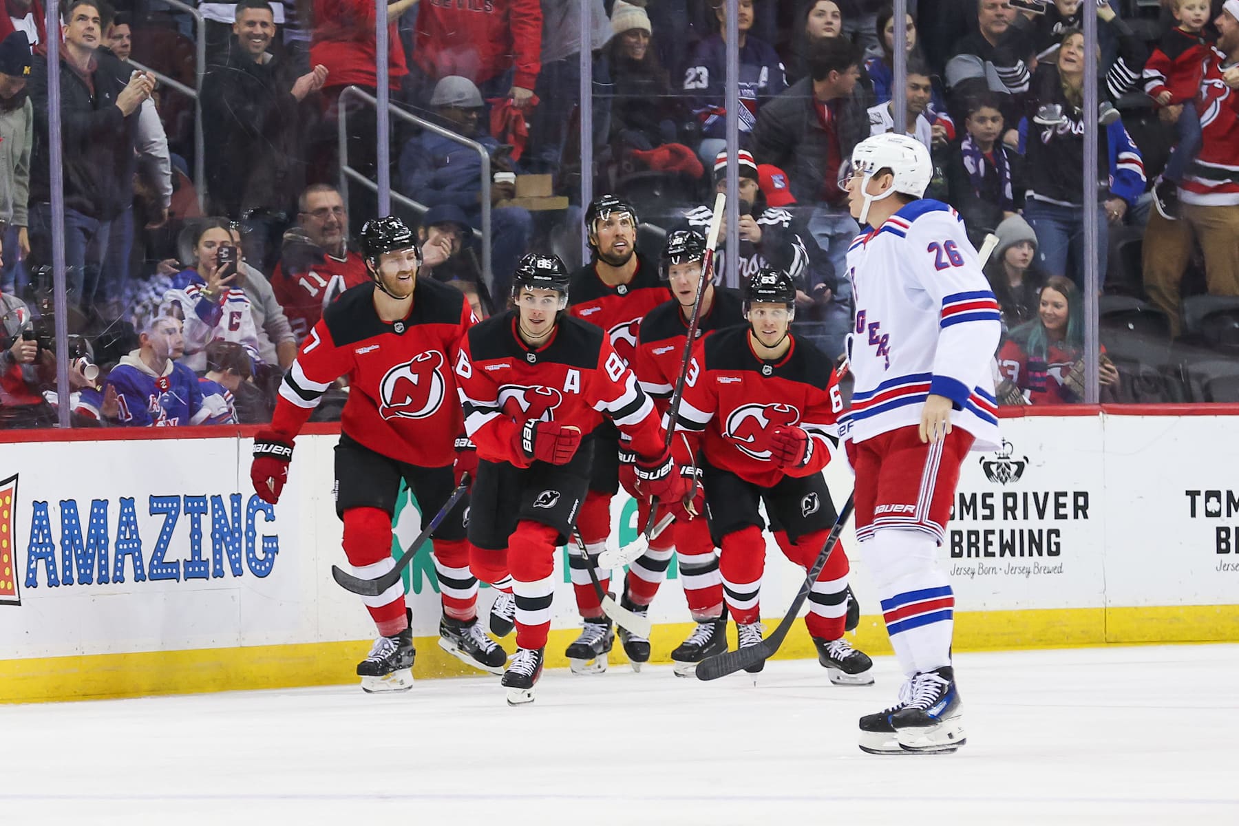 NEWARK, NJ - DECEMBER 23: New Jersey Devils center Jack Hughes (86) celebrates after scoring a goal during a NHL game between the New York Rangers and New Jersey Devils at Prudential Center on December 23, 2024 in Newark, New Jersey. (Photo by Andrew Mordzynski/Icon Sportswire via Getty Images)