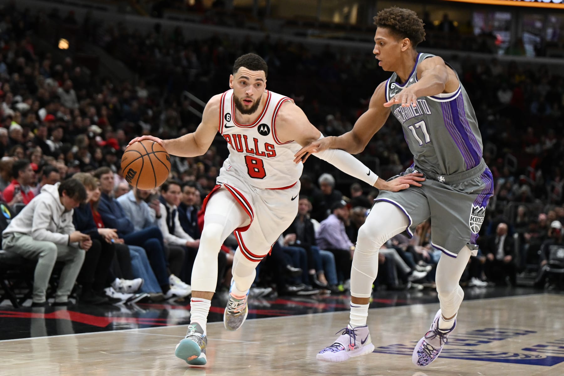 CHICAGO, ILLINOIS - MARCH 15: Zach LaVine #8 of the Chicago Bulls drives down the court against Kessler Edwards #17 of the Sacramento Kings in the first half of the game at United Center on March 15, 2023 in Chicago, Illinois.   NOTE TO USER: User expressly acknowledges and agrees that, by downloading and or using this photograph, User is consenting to the terms and conditions of the Getty Images License Agreement.  (Photo by Quinn Harris/Getty Images)