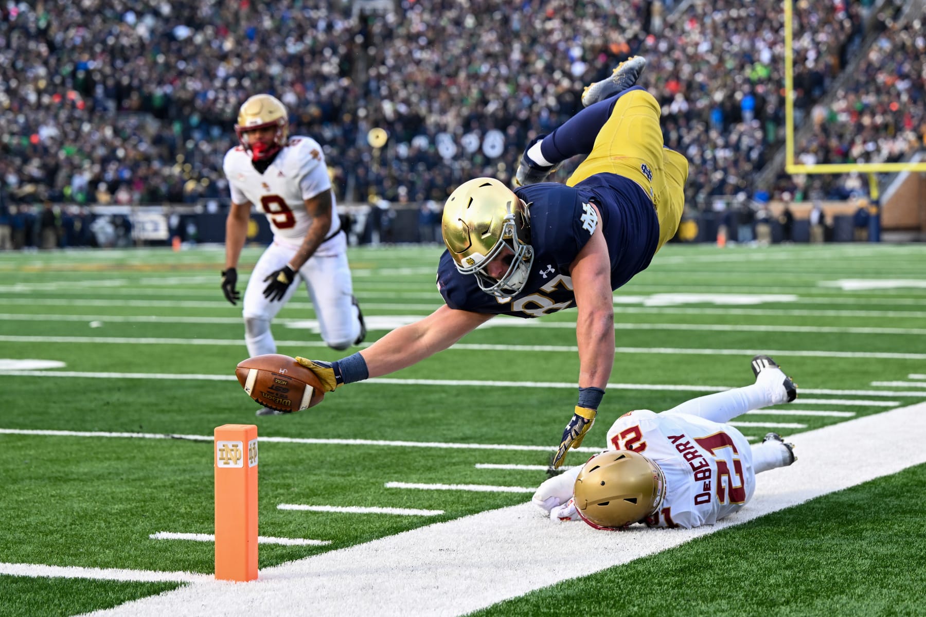 SOUTH BEND, INDIANA - NOVEMBER 19: Michael Mayer #87 of the Notre Dame Fighting Irish dives just short of the touchdown in the first half against Josh DeBerry #21 of the Boston College Eagles at Notre Dame Stadium on November 19, 2022 in South Bend, Indiana. (Photo by Quinn Harris/Getty Images)