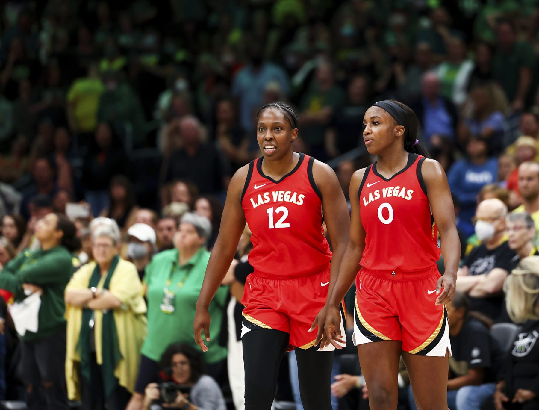 Las Vegas Aces guard Chelsea Gray (12) and guard Jackie Young (0) look on during the second half of Game 4 of a WNBA basketball playoff semifinal against the Seattle Storm Tuesday, Sept. 6, 2022, in Seattle. The Aces beat the Storm 97-92 to advance to the WNBA Finals. (AP Photo/Lindsey Wasson)