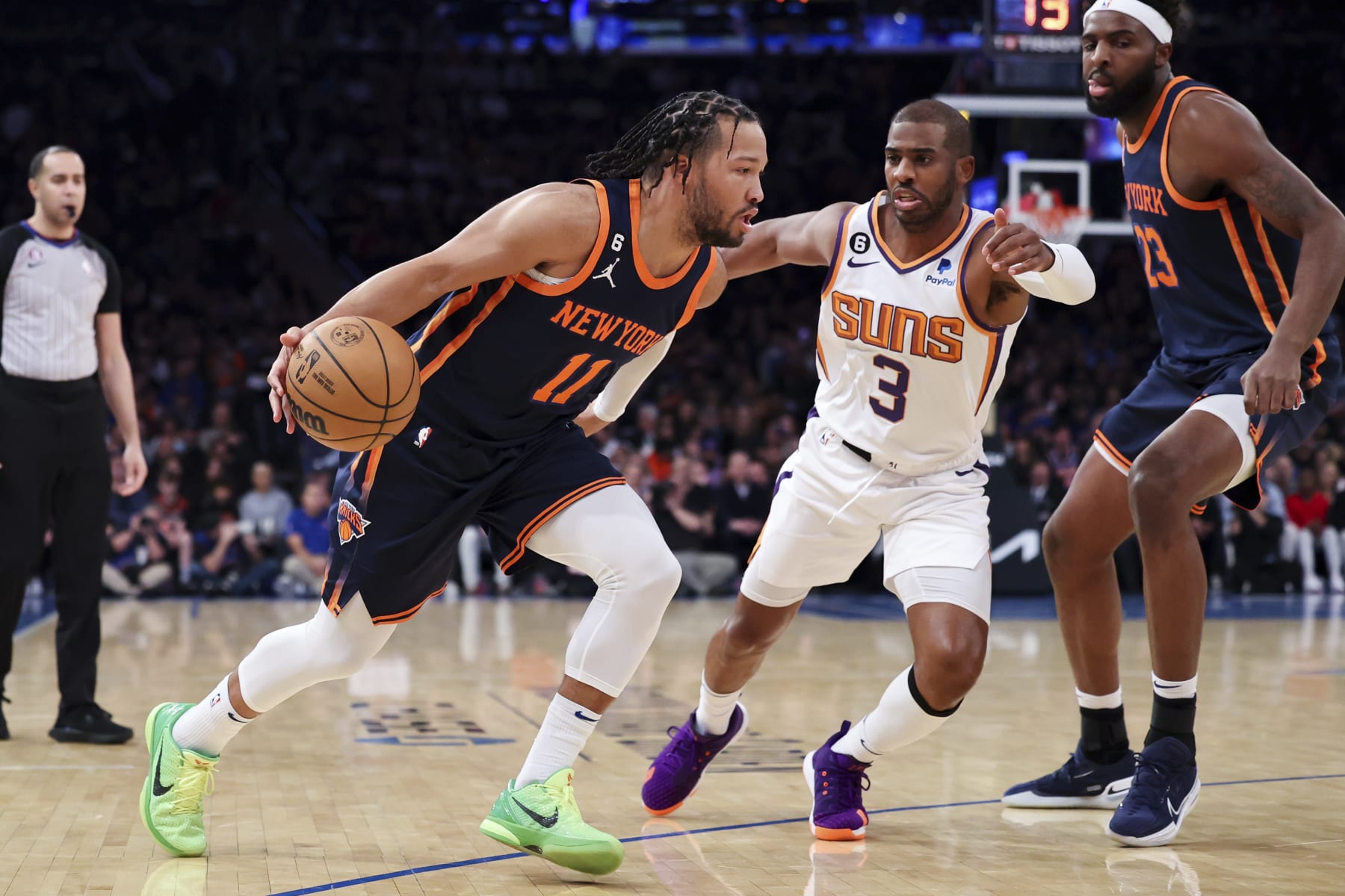 New York Knicks guard Jalen Brunson (11) dribbles against Phoenix Suns guard Chris Paul (3) as New York Knicks center Mitchell Robinson (23) watches during the first half of an NBA basketball game, Monday, Jan. 2, 2023, in New York. (AP Photo/Jessie Alcheh)