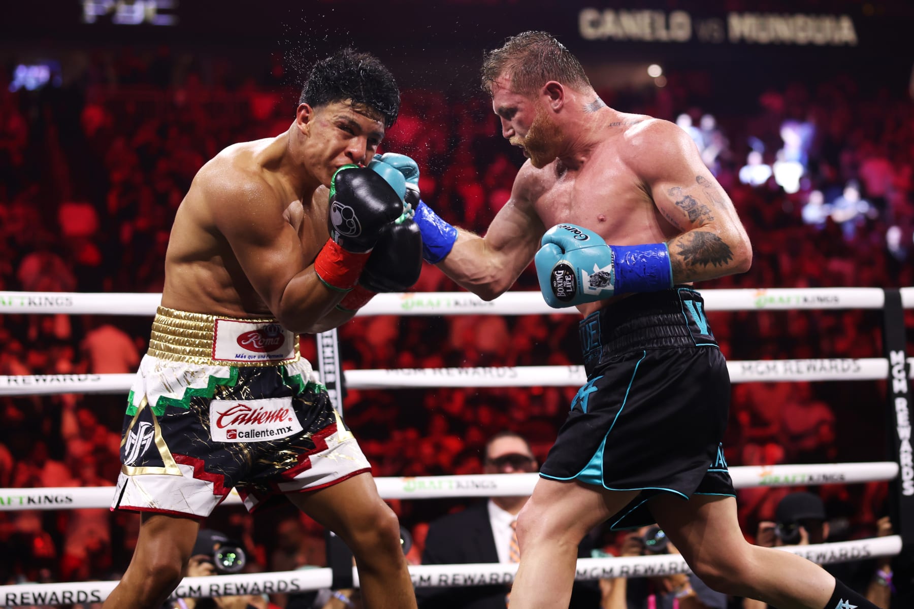 LAS VEGAS, NEVADA - MAY 04: Canelo Alvarez of Mexico (R) and Jaime Munguia (L) exchange punches during their super middleweight title fight at T-Mobile Arena on May 04, 2024 in Las Vegas, Nevada. (Photo by Cris Esqueda/Golden Boy/Getty Images)