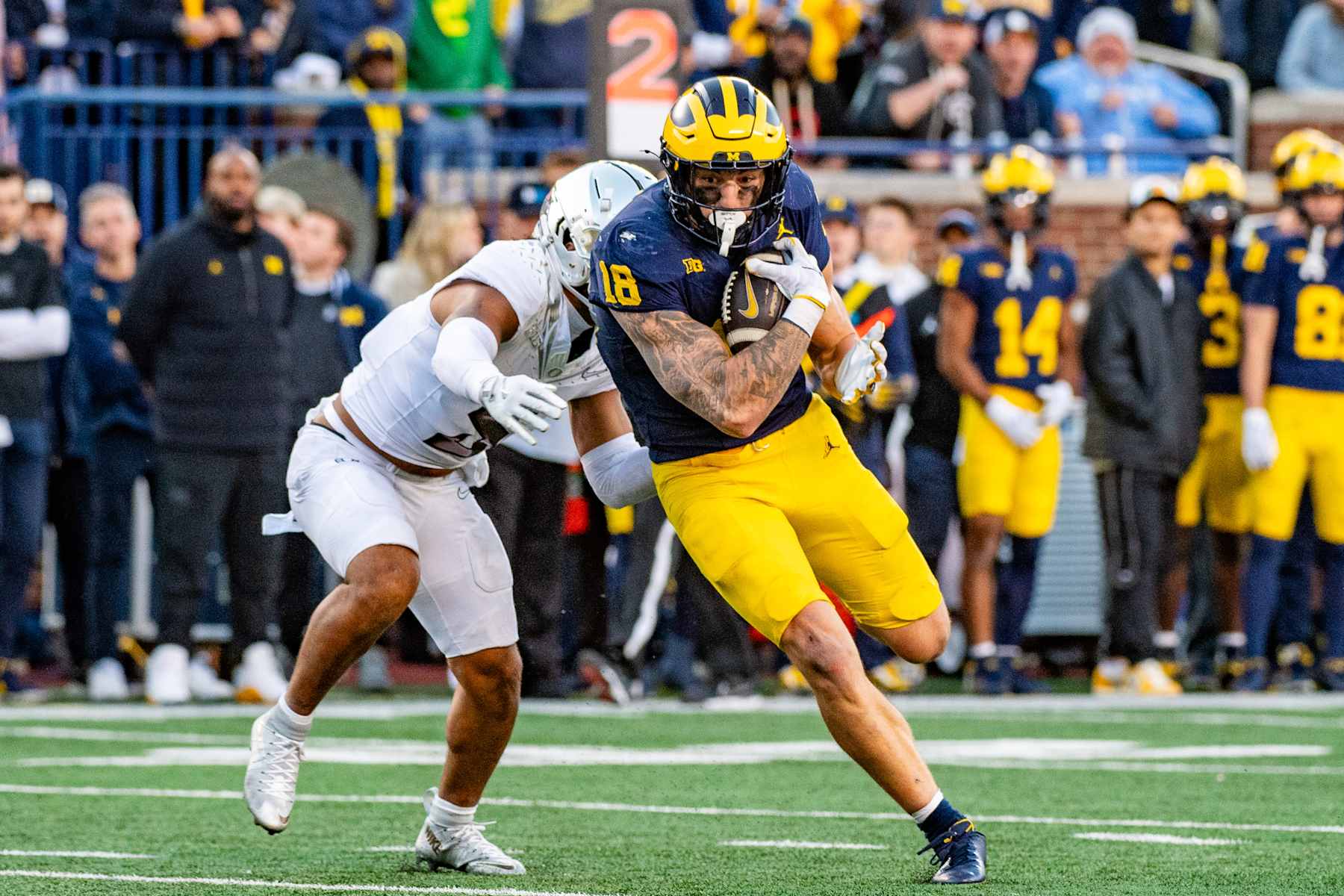 ANN ARBOR, MICHIGAN - NOVEMBER 02: Colston Loveland #18 of the Michigan Wolverines runs with the ball against Kobe Savage #5 of the Oregon Ducks during the second half of a college football game at Michigan Stadium on November 02, 2024 in Ann Arbor, Michigan. The Oregon Ducks won the game 38-17. (Photo by Aaron J. Thornton/Getty Images)