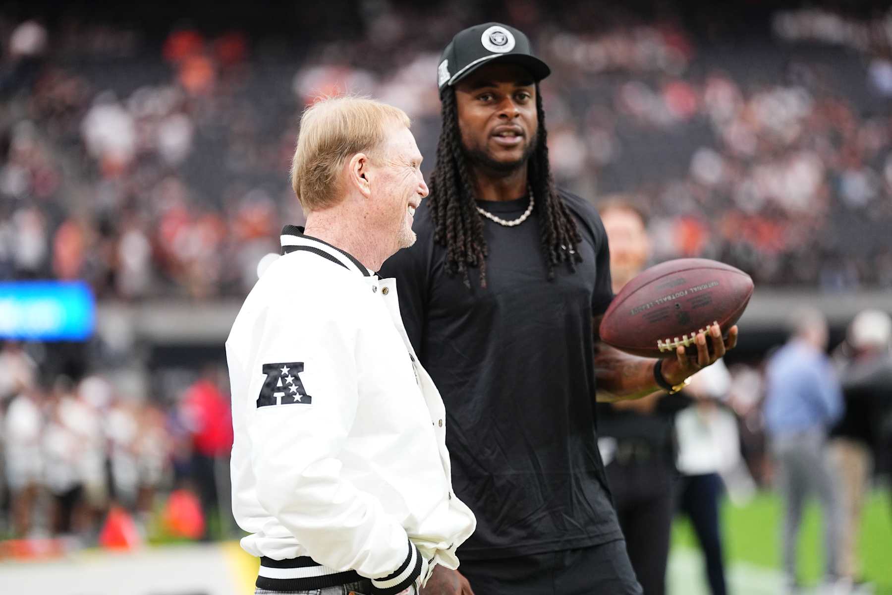 LAS VEGAS, NEVADA - SEPTEMBER 29: Wide receiver Davante Adams #17 of the Las Vegas Raiders (R) interacts with owner and managing general partner Mark Davis of the Las Vegas Raiders before the game against the Cleveland Browns at Allegiant Stadium on September 29, 2024 in Las Vegas, Nevada. The Raiders defeated the Browns 20-16.  (Photo by Jeff Bottari/Getty Images)