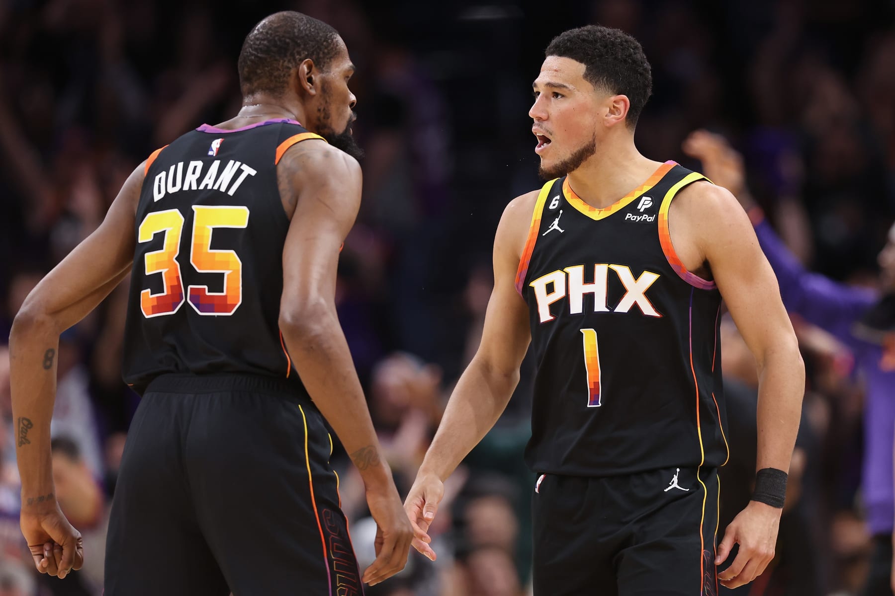 PHOENIX, ARIZONA - MAY 05: Devin Booker #1 and Kevin Durant #35 of the Phoenix Suns celebrate during Game Three of the NBA Western Conference Semifinals at Footprint Center on May 05, 2023 in Phoenix, Arizona.  The Suns defeated the Nuggets 121-114. NOTE TO USER: User expressly acknowledges and agrees that, by downloading and or using this photograph, User is consenting to the terms and conditions of the Getty Images License Agreement.  (Photo by Christian Petersen/Getty Images)