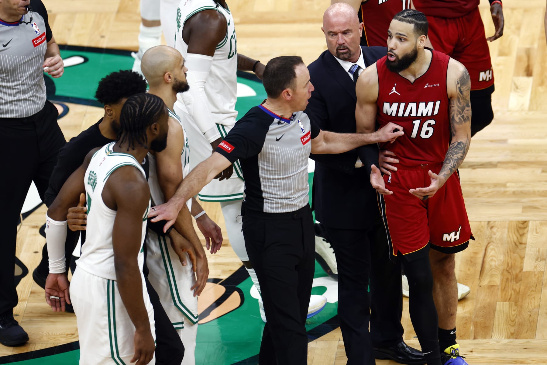 Boston, MA - April 21: Officials separate Boston Celtics guard Jaylen Brown and Miami Heat forward Caleb Martin after Martin fouled forward Jayson Tatum (not pictured) in the fourth quarter. (Photo by Danielle Parhizkaran/The Boston Globe via Getty Images) Boston, MA - April 21: Officials separate Boston Celtics guard Jaylen Brown and Miami Heat forward Caleb Martin after Martin fouled forward Jayson Tatum (not pictured) in the fourth quarter. (Photo by Danielle Parhizkaran/The Boston Globe via Getty Images)