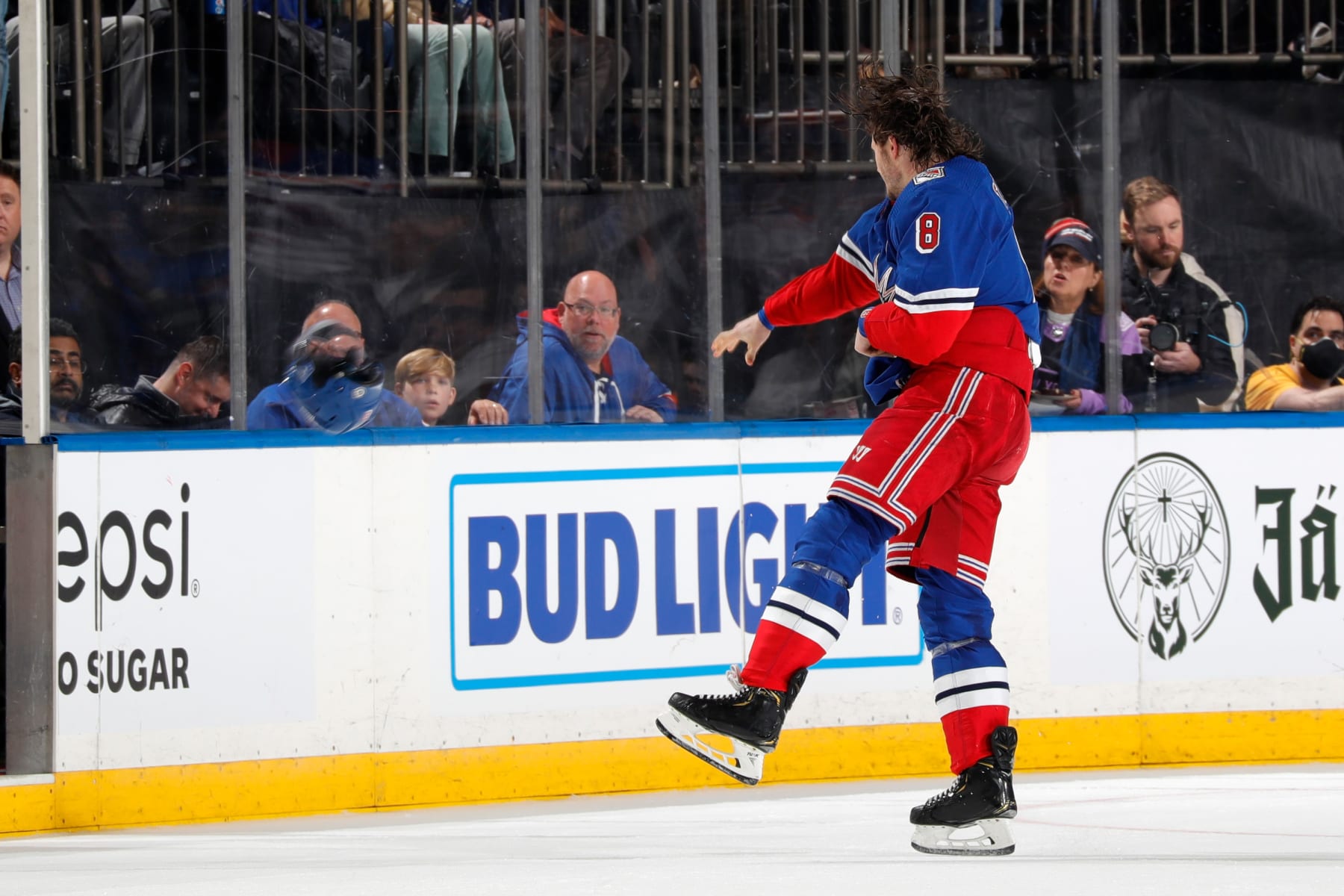NEW YORK, NEW YORK - DECEMBER 03:  Jacob Trouba #8 of the New York Rangers throws his helmet in anger after a fight against the Chicago Blackhawks at Madison Square Garden on December 3, 2022 in New York City. (Photo by Jared Silber/NHLI via Getty Images)