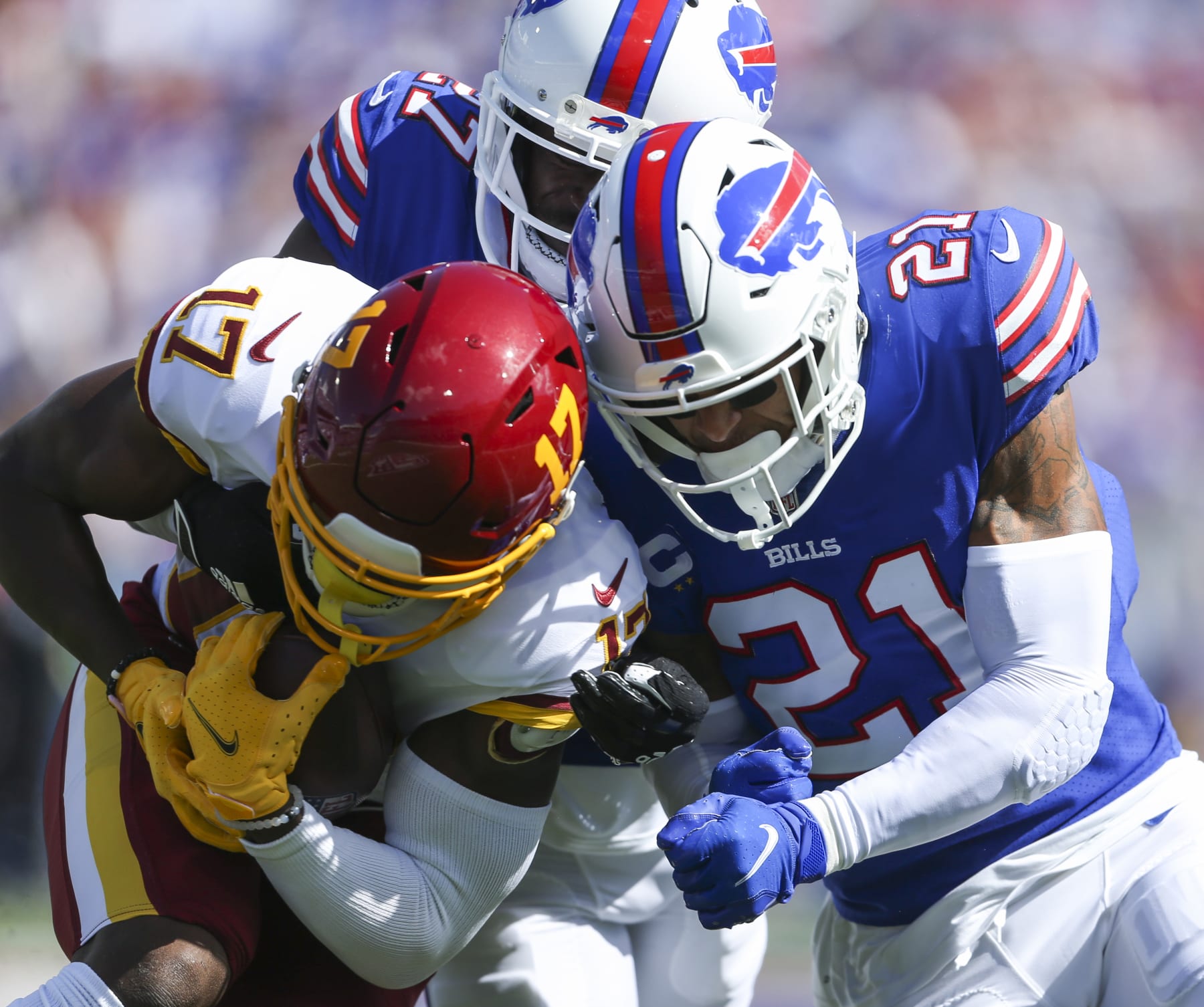 ORCHARD PARK, NEW YORK - SEPTEMBER 26: Tre'Davious White #27 of the Buffalo Bills and Jordan Poyer #21 tackle Terry McLaurin #17 of the Washington Football Team during the first quarter of the game at Highmark Stadium on September 26, 2021 in Orchard Park, New York. (Photo by Joshua Bessex/Getty Images)