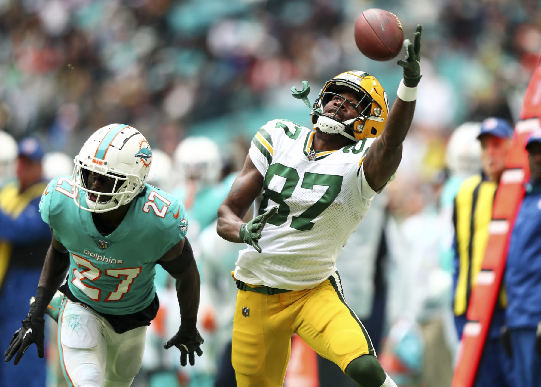 MIAMI GARDENS, FL - DECEMBER 25: Romeo Doubs #87 of the Green Bay Packers attempts to make a one-handed catch during the fourth quarter of an NFL football game against the Miami Dolphins at Hard Rock Stadium on December 25, 2022 in Miami Gardens, Florida. (Photo by Kevin Sabitus/Getty Images)