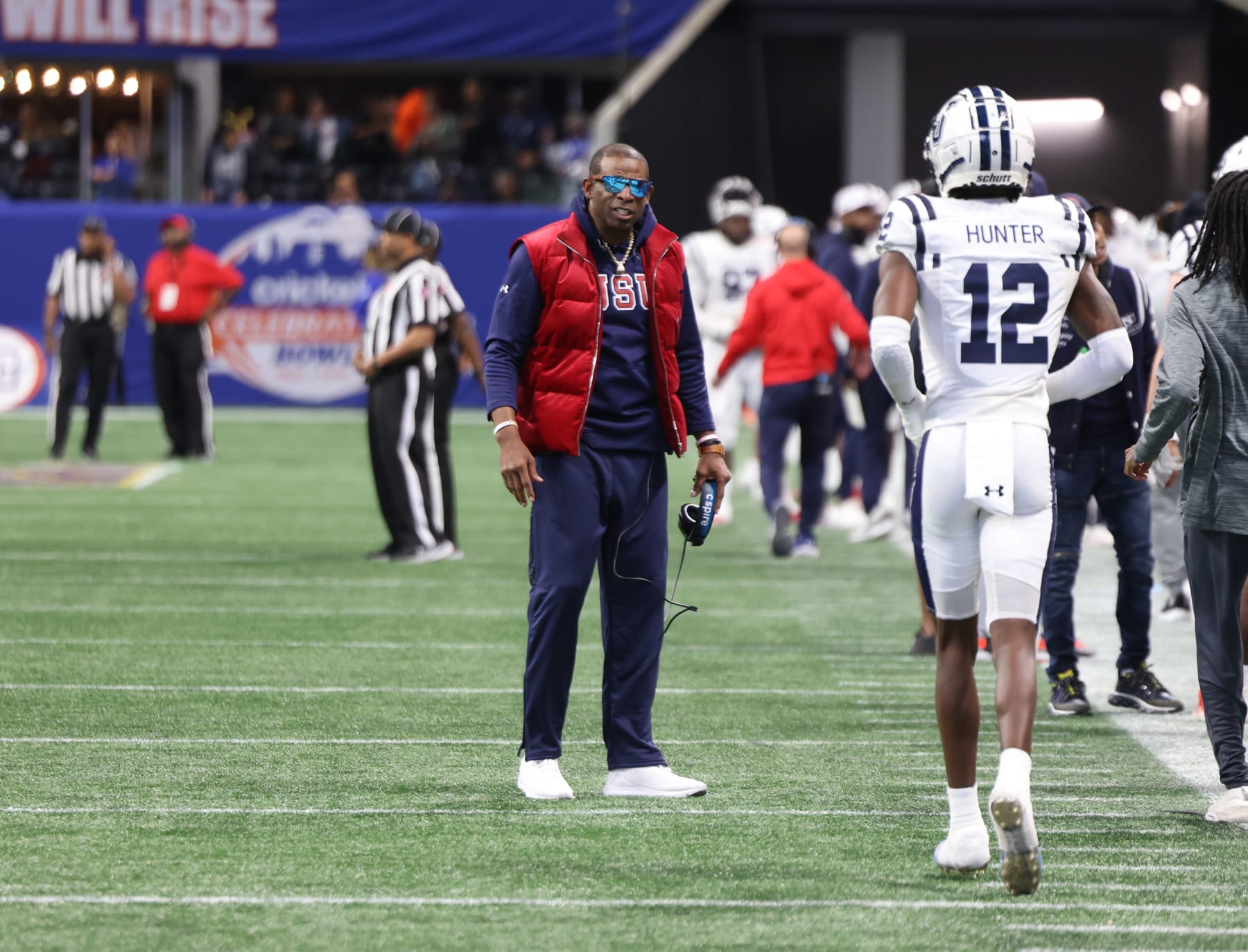 ATLANTA, GA - DECEMBER 17: Coach Deion Sanders talks with Travis Hunter during the Jackson State Tigers and North Carolina Central Eagles Celebration Bowl Football Championship game at Mercedes Benz Stadium on December 17, 2022, in Atlanta, GA (Photo by Charles A. Smith/Jackson State University via Getty Images)