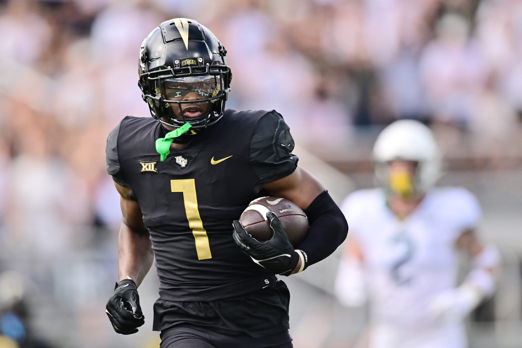 ORLANDO, FLORIDA - SEPTEMBER 30: Javon Baker #1 of the UCF Knights catches a 65-yard touchdown pass in the first quarter against the Baylor Bears at FBC Mortgage Stadium on September 30, 2023 in Orlando, Florida. (Photo by Julio Aguilar/Getty Images)